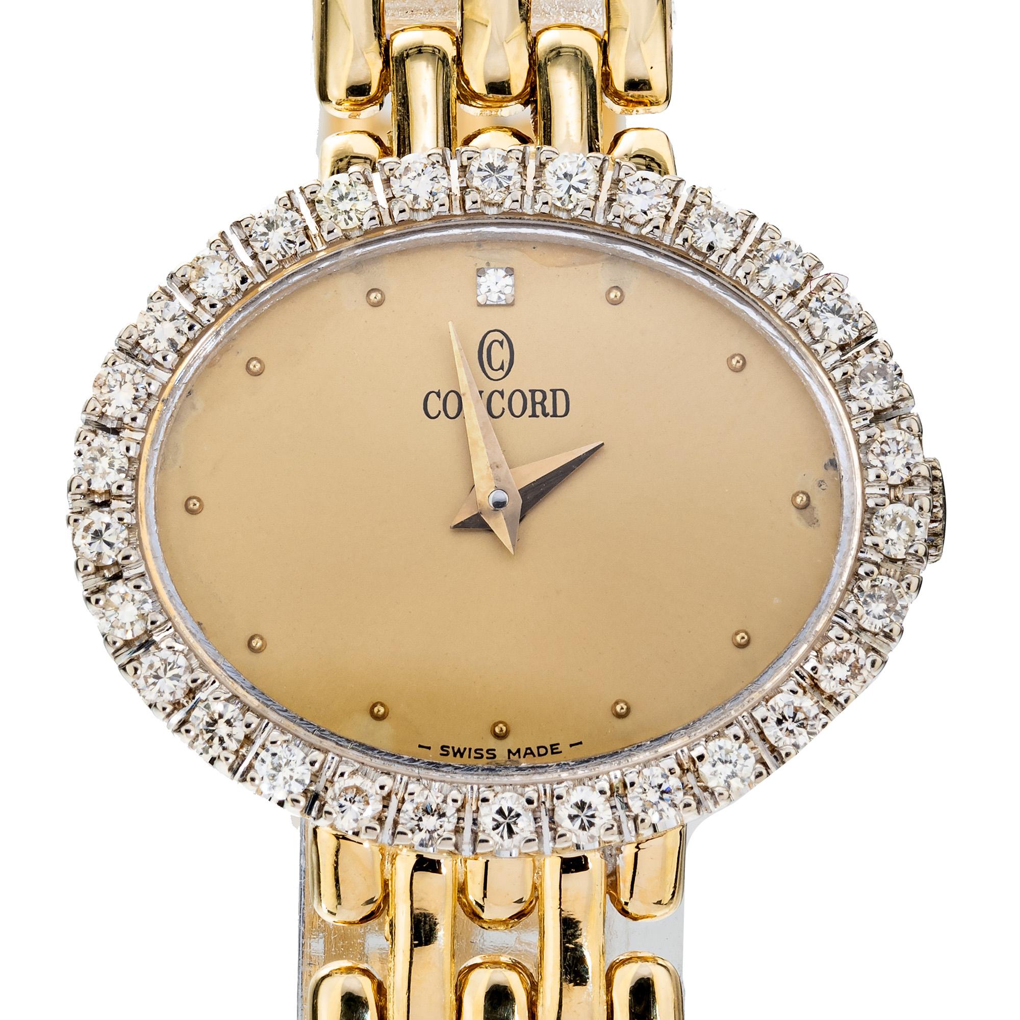Diamond gold Concord Ladies quartz wristwatch. Oval dial with an 18k yellow gold a bezel halo of round cut diamonds. A single round diamond sits at the 12 O'clock position. The panther style band is solid 18k yellow gold.

Length: 19.20mm
Width: