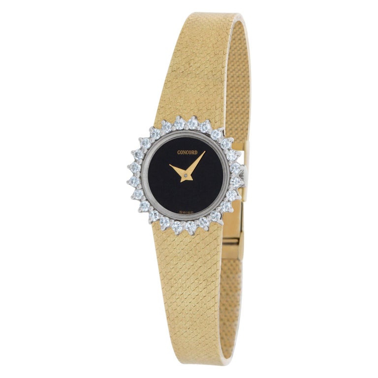 Concord in 14k yellow gold with approximately 0.70 carats in diamond bezel. Manual. 20 mm case size. Fits 6 inches wrist. Ref 2115271 BL. Circa 1970s Fine Pre-owned Concord Watch.

Certified preowned Dress Concord Classic 2115271 BL watch is made