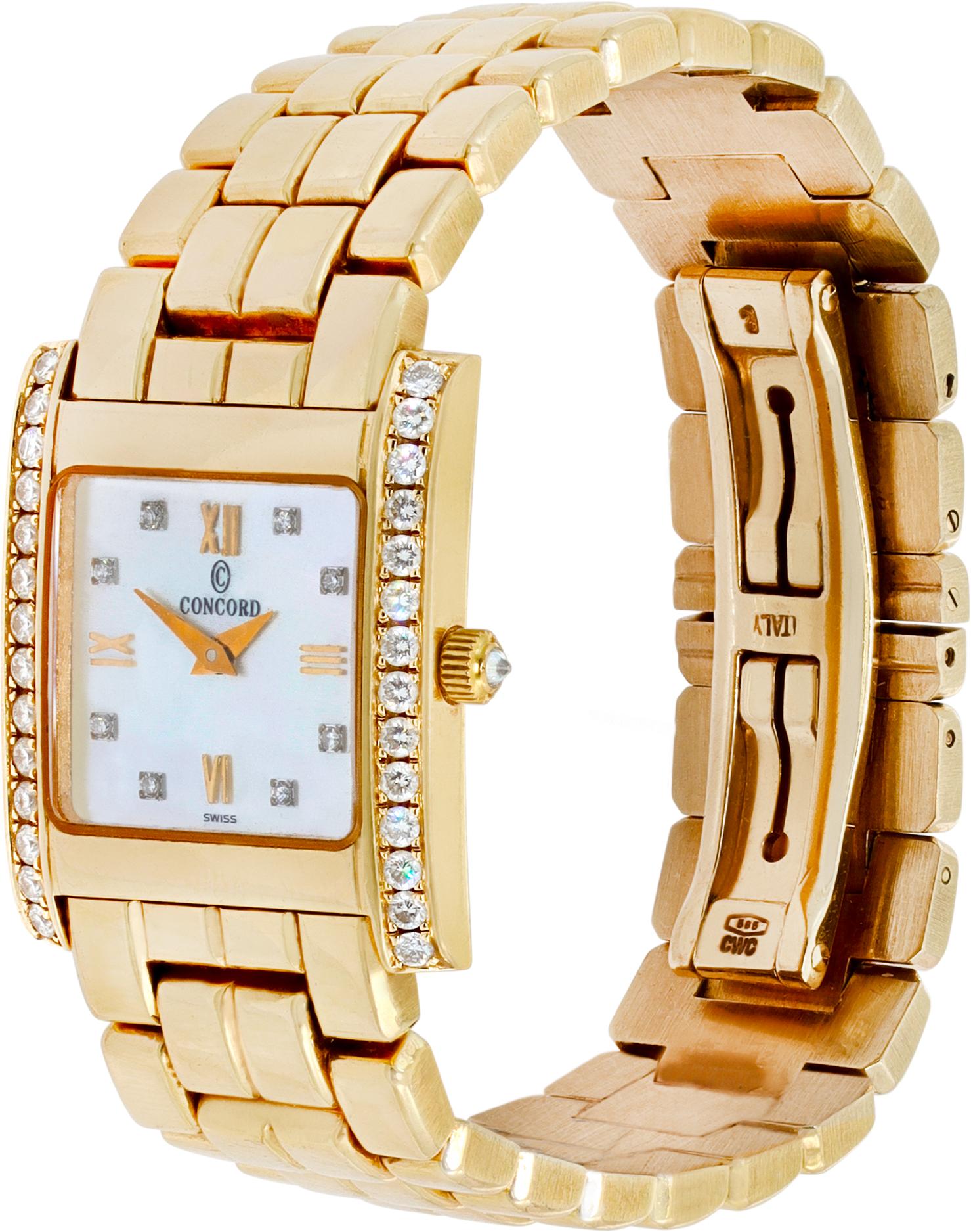 Concord in 14K yellow gold with a mother of pearl dial, diamonds and roman numerals on the hour markers. Diamond case. Quartz. 32mm length (lug to lug) by 21 mm width case size. Ref w641553. Fine Pre-owned Concord Watch.

 Certified preowned Classic