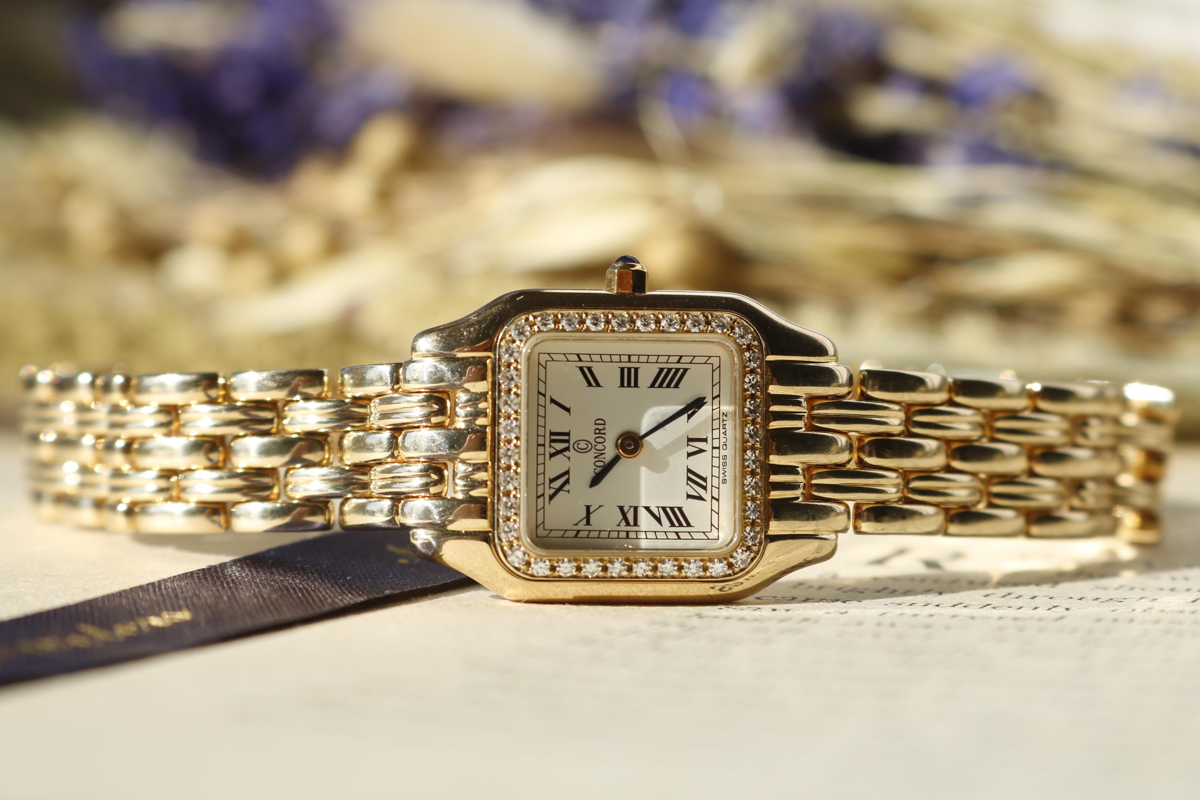 This Concord watch blends classic design with precision craftsmanship. Featuring a square face in 14K yellow gold, it is powered by a reliable quartz movement. The white dial showcases a 12-hour readout with black Roman numerals. Thirty-six round