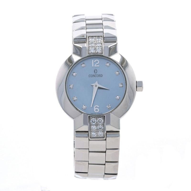 Brand: Concord
Model: La Scala 
Model Number: 14.G4.1843.S
Dial Color: Blue
Metal Content: Stainless Steel
Movement: Quartz
Warranty: One-Year

Stone Information: 
Natural Mother of Pearl
Color: Blue

Natural Diamonds 
Total Carats: .50ctw
Cut: