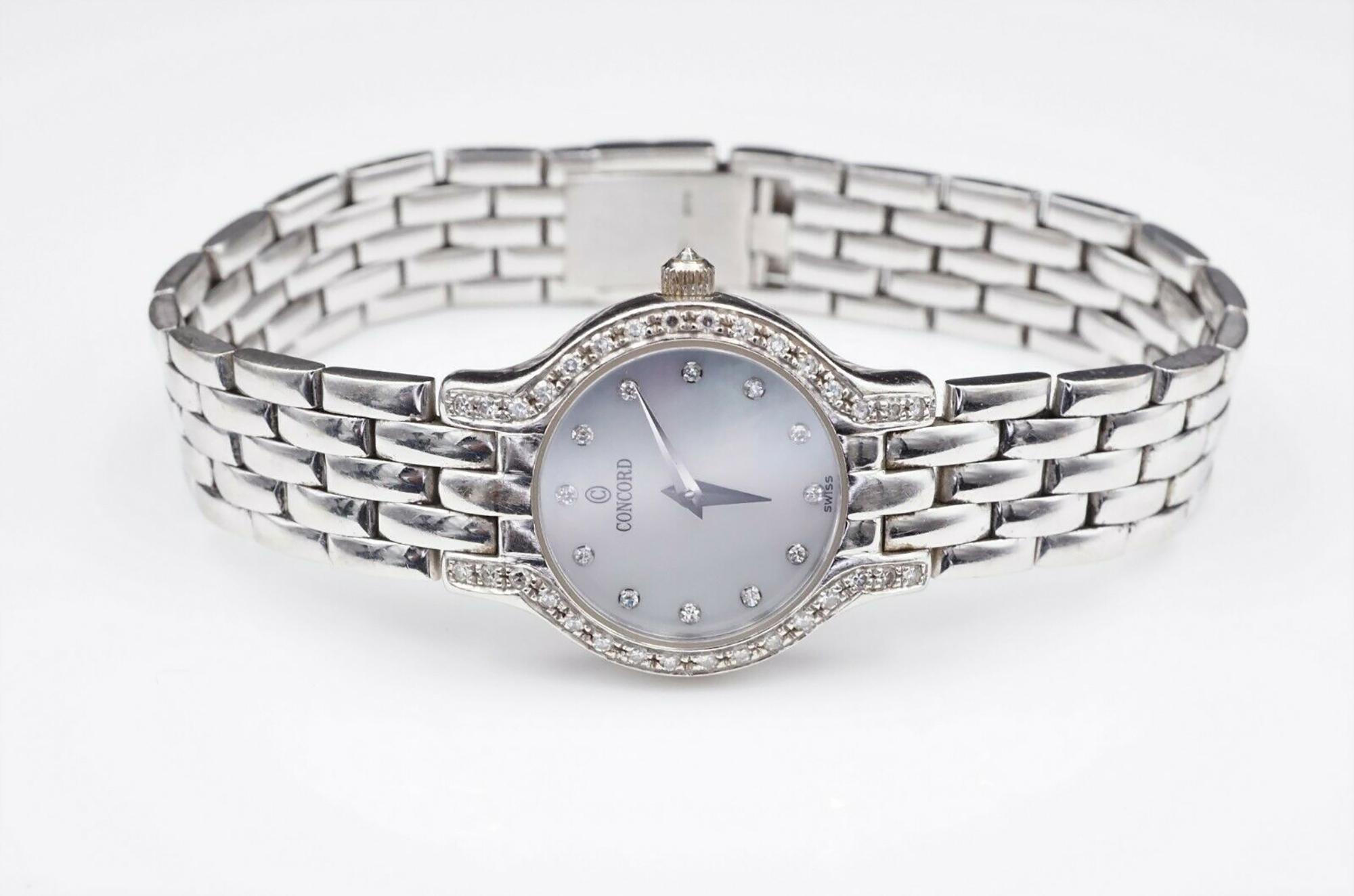 14K White Gold case and band. Mother of pearl is accented with diamond markers and is surrounded by diamond on the bezel and crown.

Serial # 69-25-266
26785