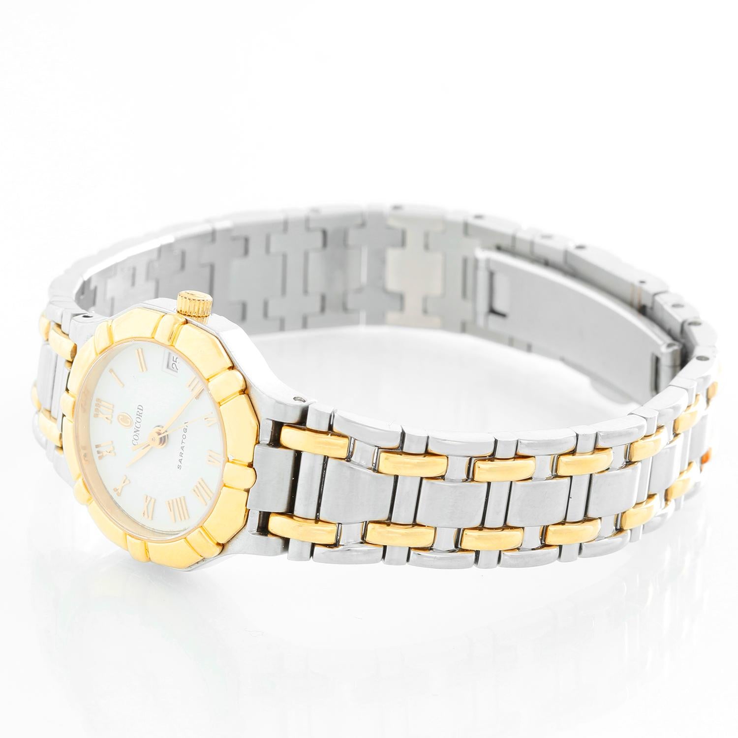 Concord  Saratoga Two- Tone Ladies Watch  - Quartz . Stainless steel and yellow gold with a smooth bezel ( 24 mm ) . White dial with raised gold Roman numerals . Two-tone bracelet; will fit up to a 6.5 inch wrist . Pre-owned Concord box and books .