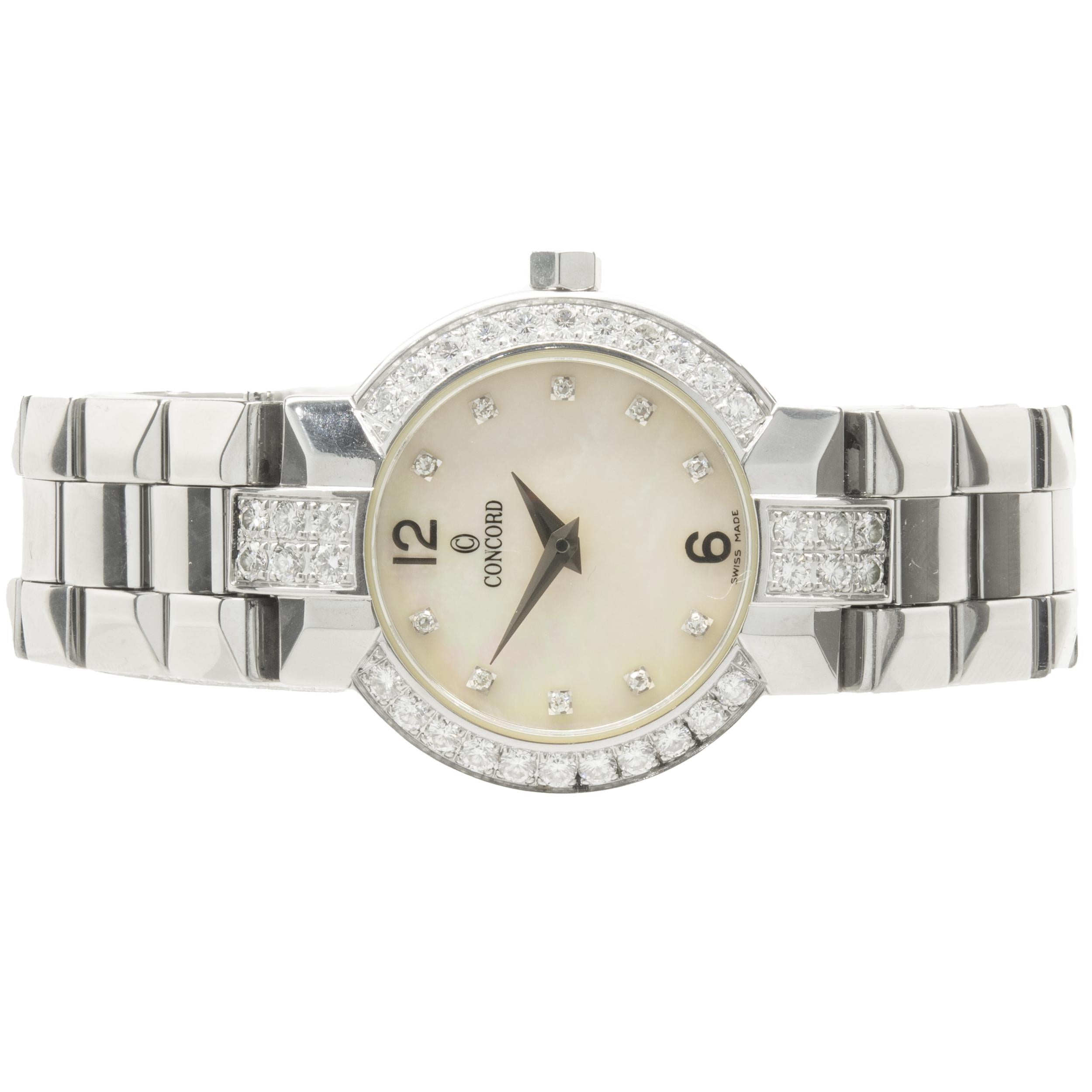 Movement: quartz
Function: hours, minutes
Case: 26mm stainless steel round case, diamond bezel, sapphire crystal, pull/push crown, water resistant
Dial: mother of pearl diamond dial
Band: Concord stainless steel La Scala bracelet, integrated