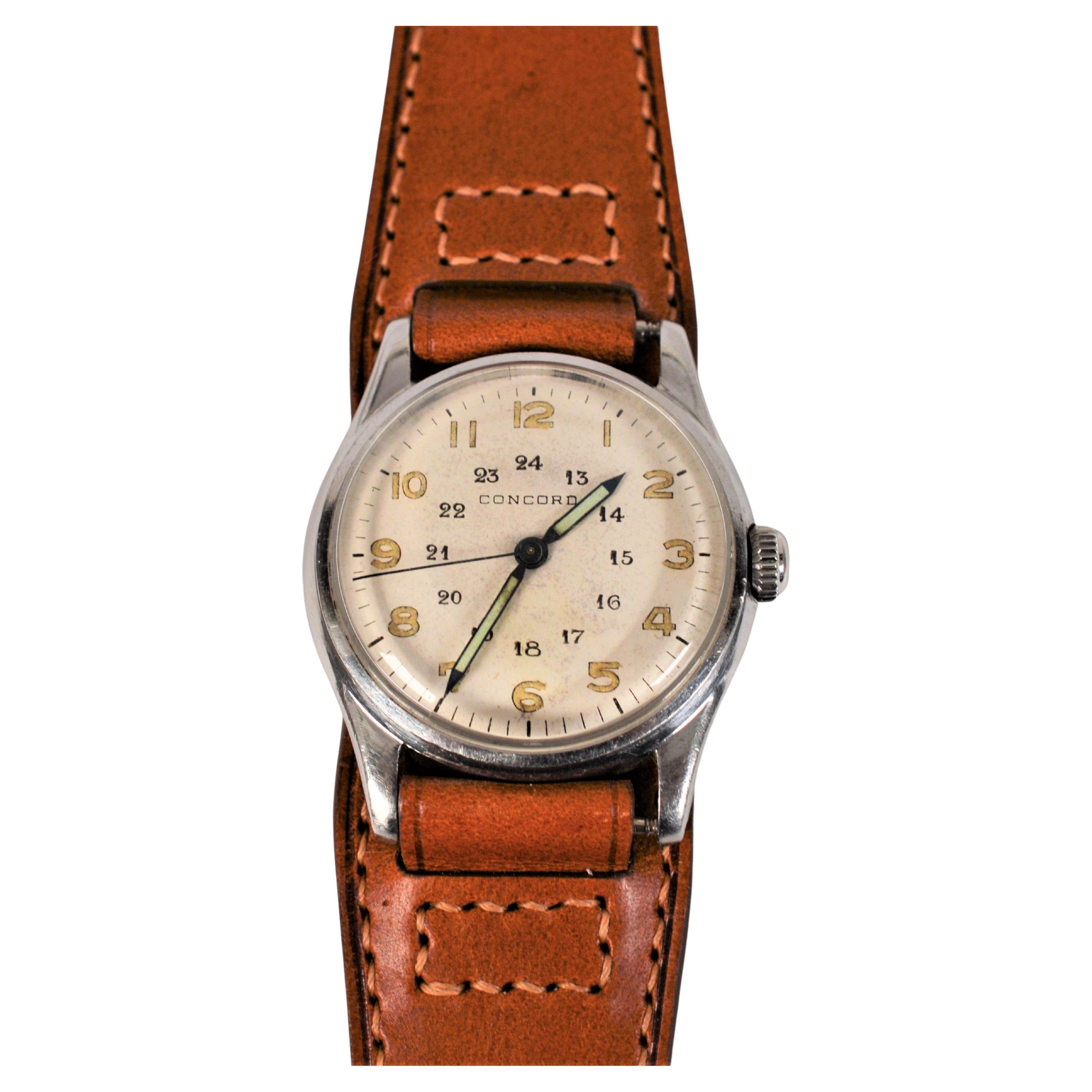 Enjoy this retro time find, circa mid 1940s. This 29mm Concord Stainless Steel WWII Era Men's Wrist Watch has an interesting 24 Hour Military style dial with illuminated spear hands. A manual wind Swiss movement powers this authentic vintage