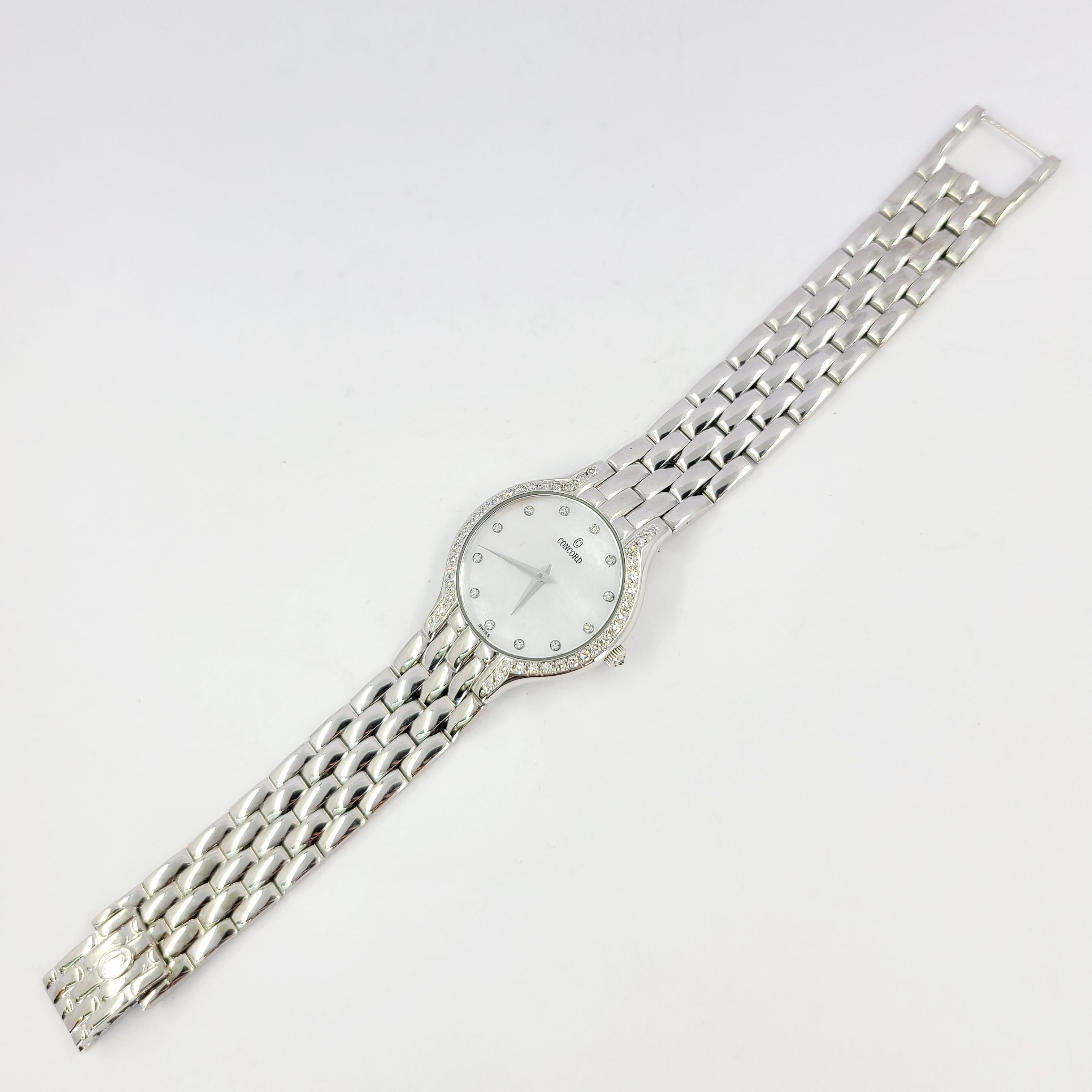 Pre-Owned 14 Karat White Gold Concord Les Palais Quartz Watch With Diamond Bezel & Mother Of Pearl Dial With Diamond Markers. 6.25 Inches Long. Finished Weight Is 52 Grams. Battery Replaced Upon Purchase, With 1 Year Timekeeping Warranty.