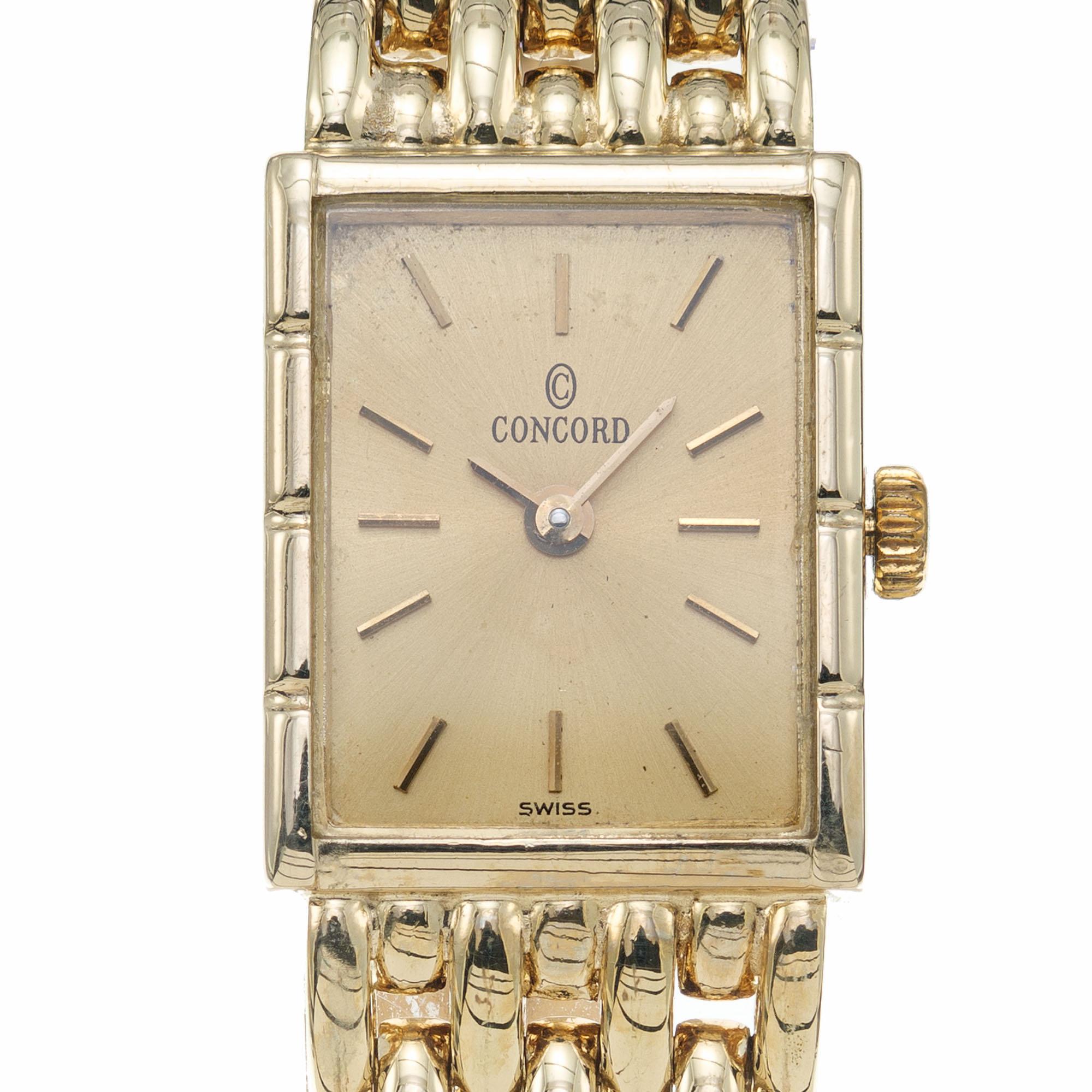 Quartz Concord ladies wristwatch with a rectangular case and 14k mesh panther style band. 

Length: 18.52mm
Width: 15mm
Weight: 38.5 grams
Band width at case: 12.84mm
Case thickness: 4.82mm
Band: 14k yellow gold panther band
Crystal: sapphire
Dial: