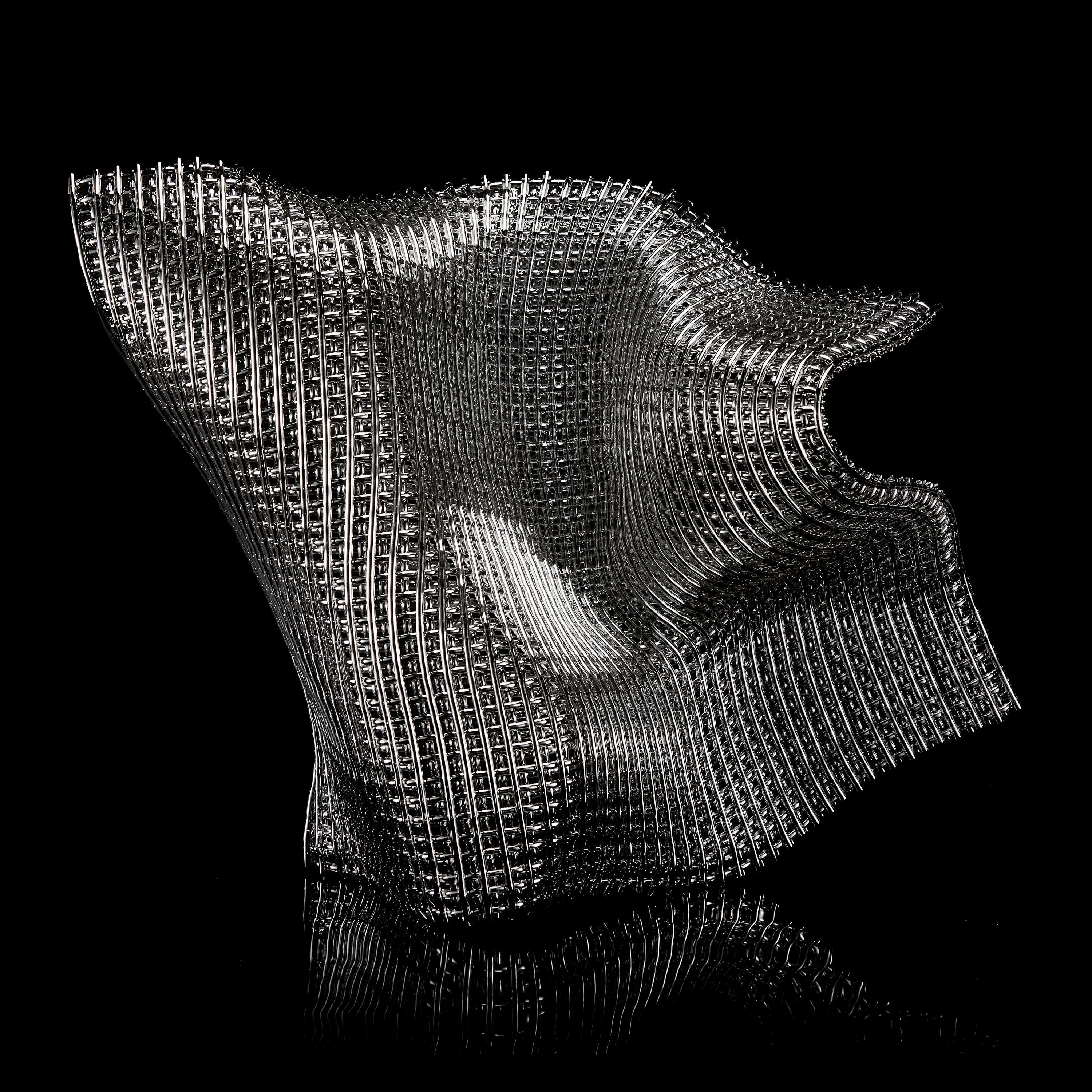 Concordance, is a unique silver and glass sculpture by the British artist Cathryn Shilling. Using her signature woven glass 'fabric' technique, Shilling layers kiln formed glass cane to create this beautiful latticed artwork, which has been finished