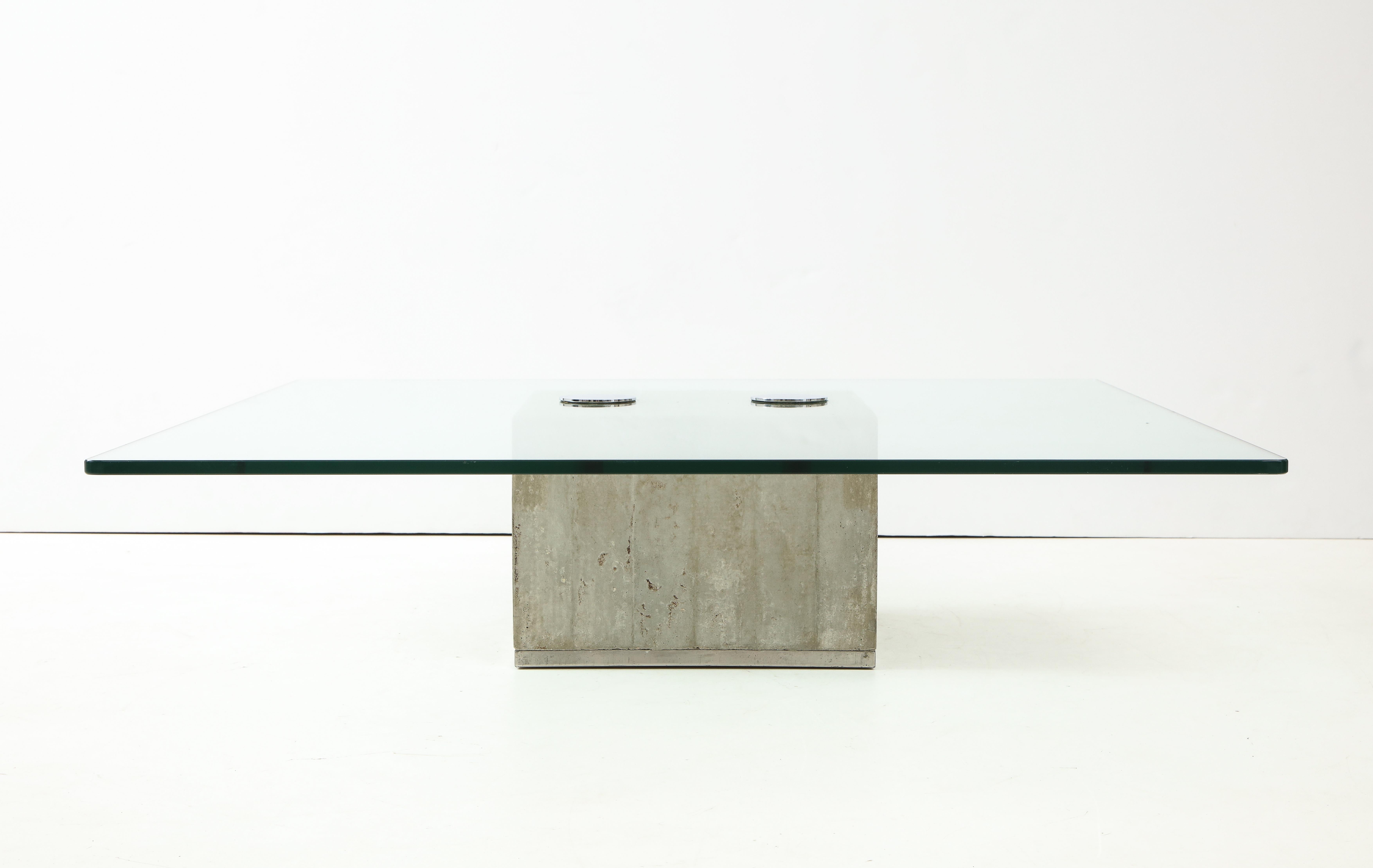 Modern Minimalist SAPO coffee table by Saporiti.
The raw concrete block supports a glass top secured by two polished chrome knobs to
create a sleek coffee table.