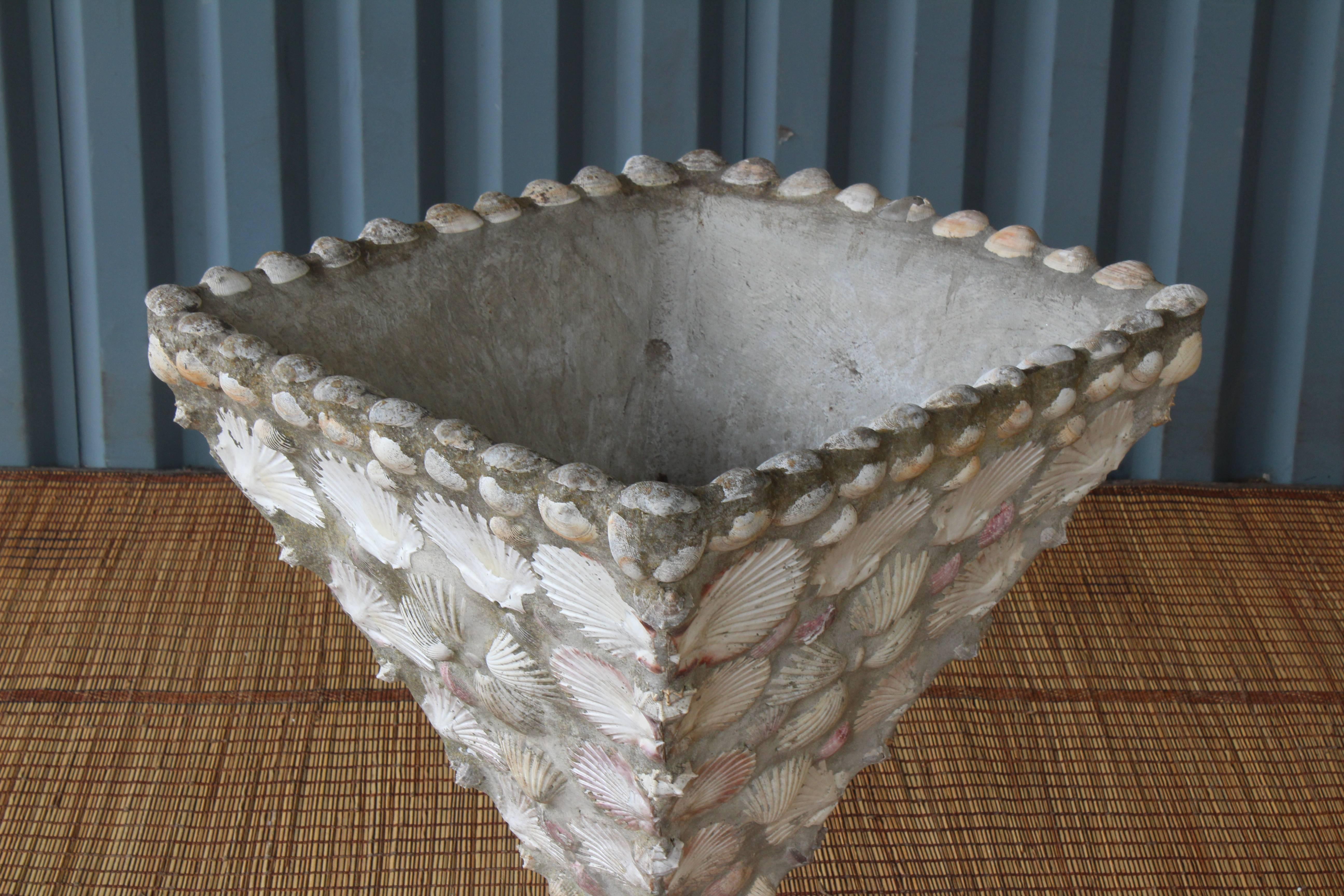 A 1960s concrete planter embossed with various types of sea shells.