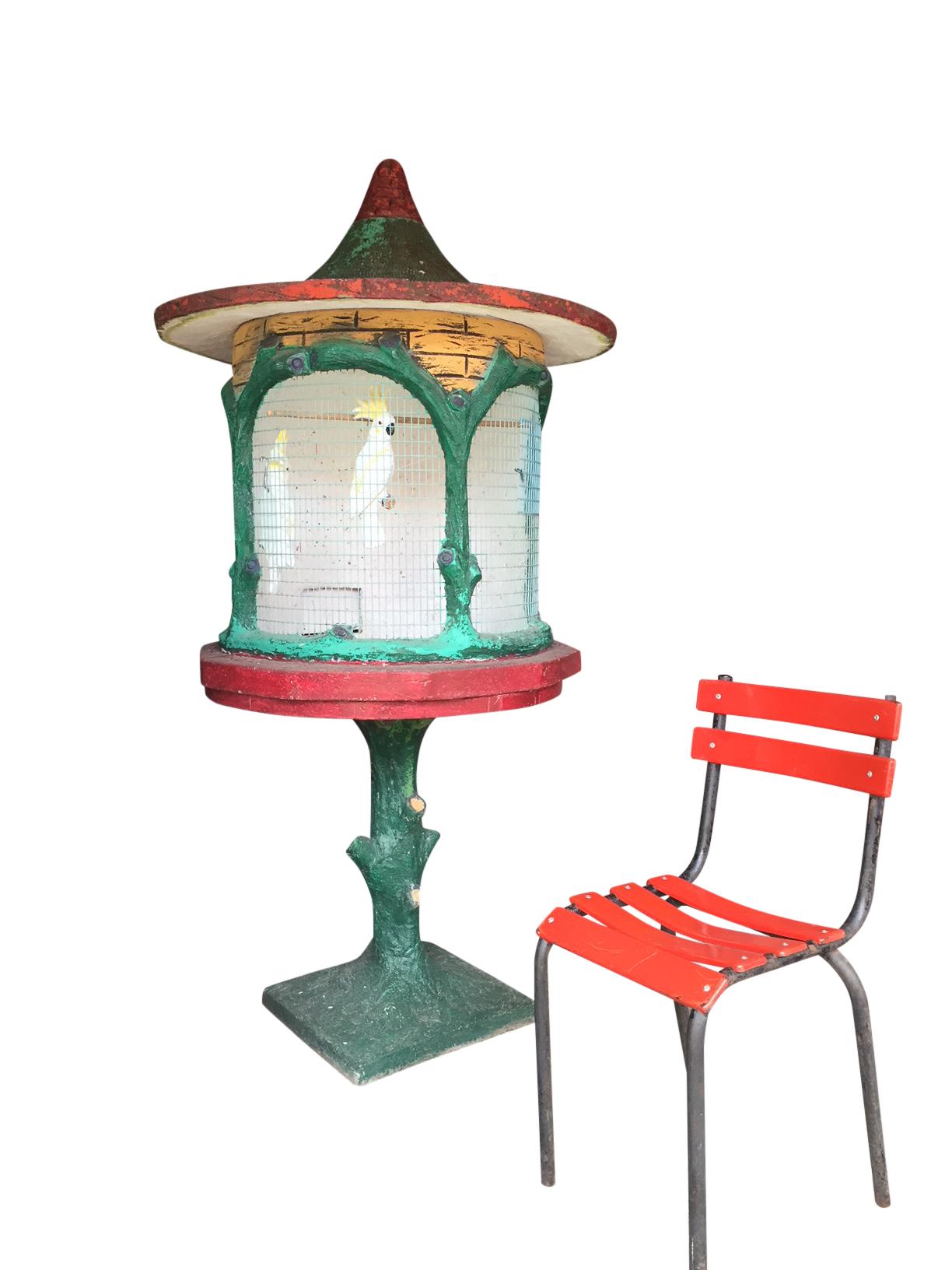Great Garden Ornament , this Outside Birdcage for Garden , Patio or Terrace . 
Made of concrete - composition stone with great use of colors.
Exists of 3 parts: base - cage and the roof. 

Even great to use as an Interior Accent ; 
this can be at