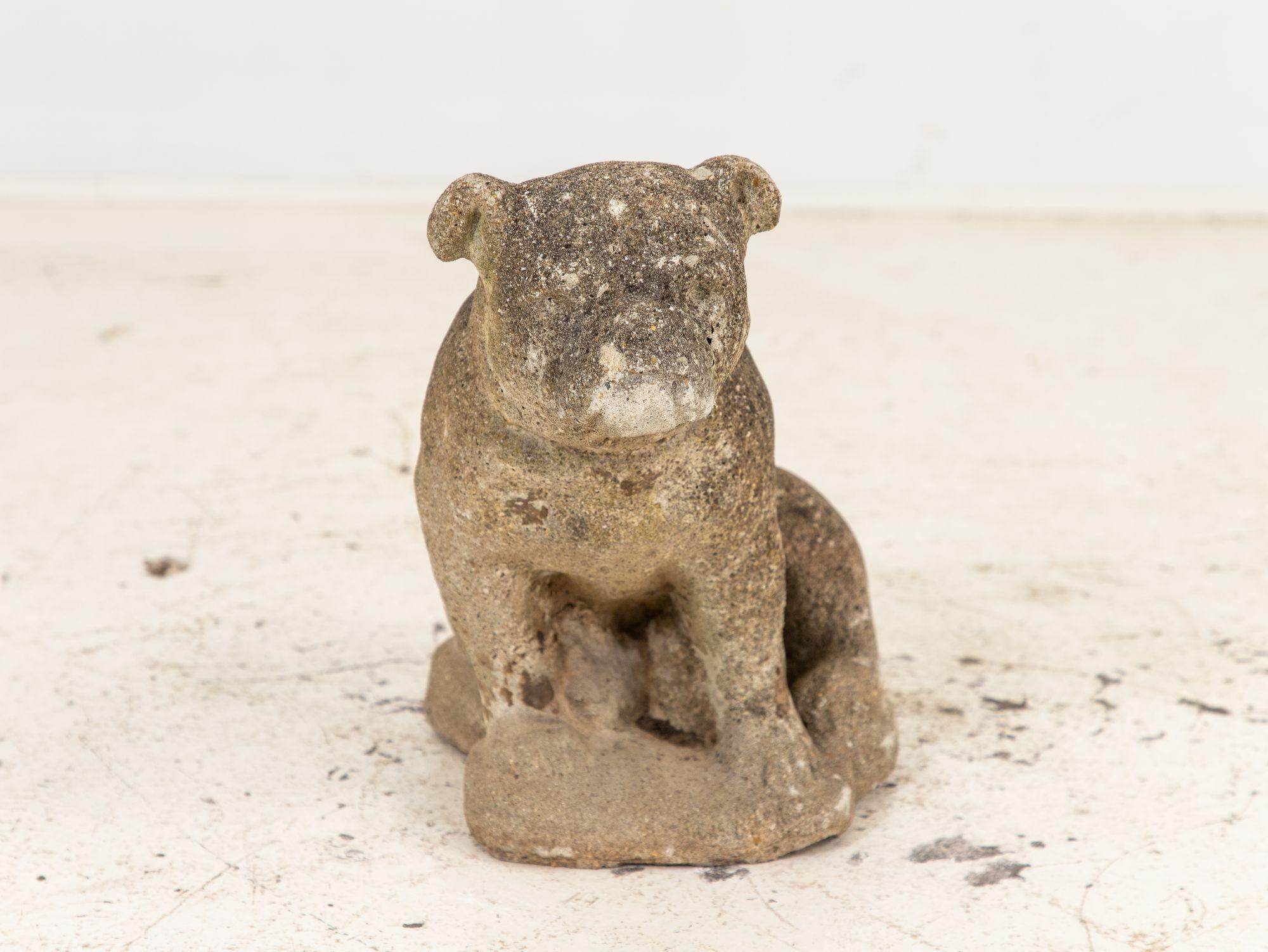 This mid-20th-century English Bulldog garden ornament, crafted from concrete, showcases a captivating patina that enhances its charm. Despite minor imperfections, it retains its original form with remarkable integrity. The coveted patina, with