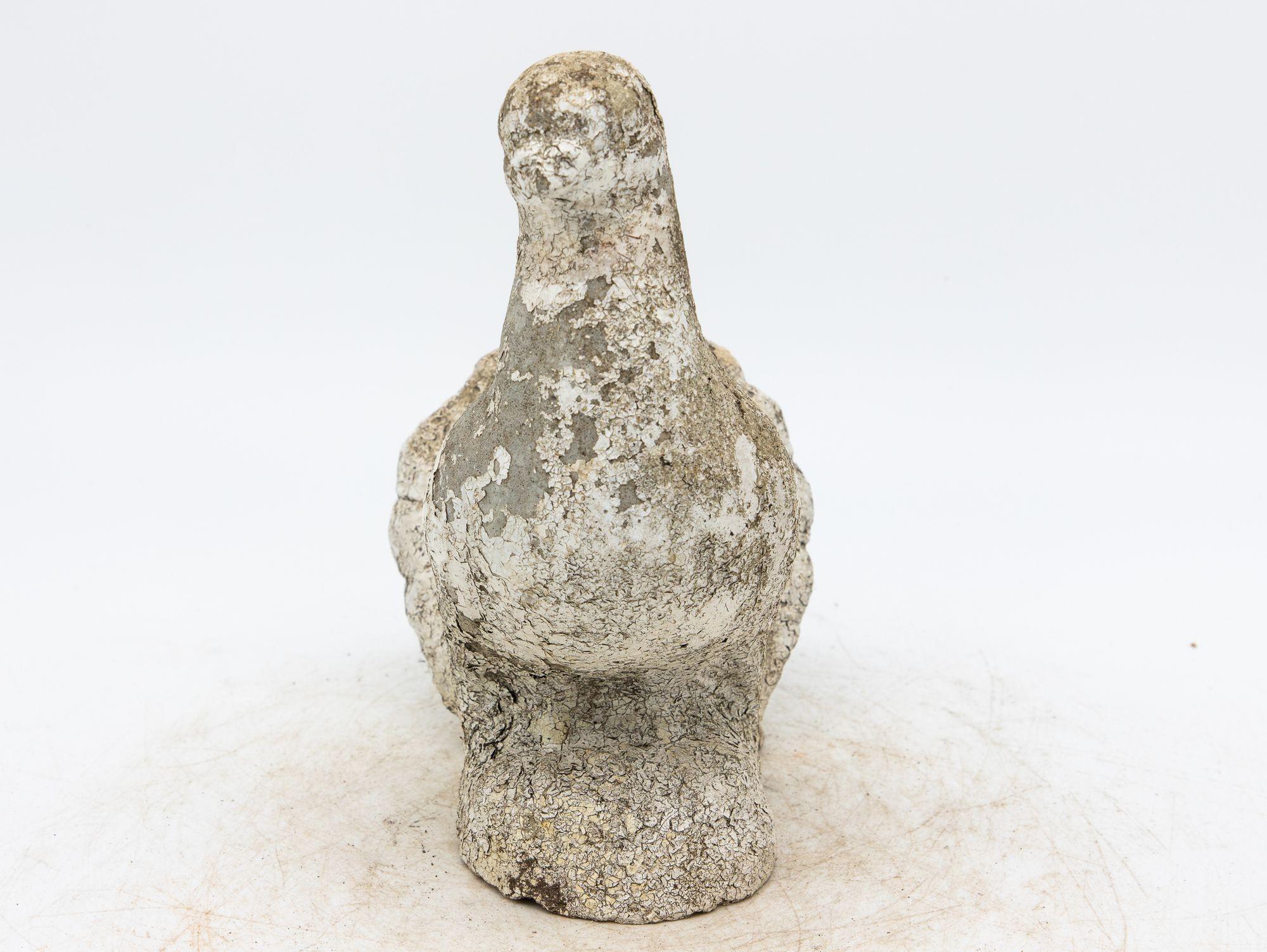 This beautiful concrete stone dove garden ornament has a modest and graceful design that brings a sense of peace and serenity to your outdoor decor. The dove is perched on a rock with subtle details on the tail feathers, face, and talons. Remnants