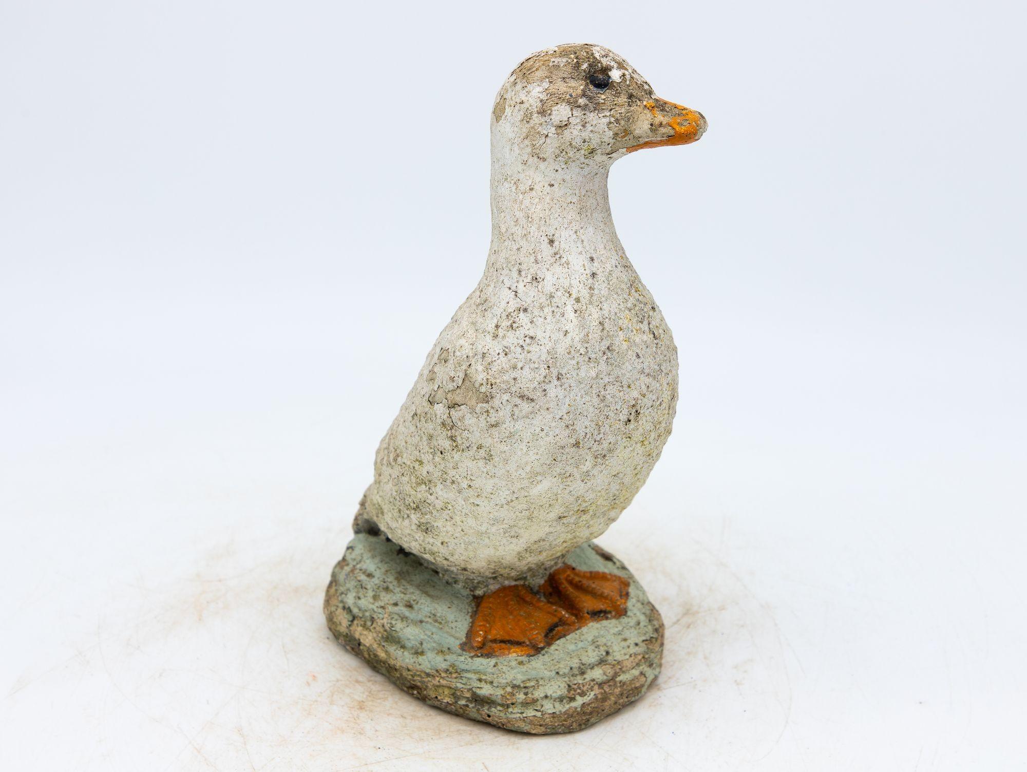 Capture the enchantment of a vintage French garden with this charming duck ornament. Crafted from durable concrete, it stands as a testament to both artistry and timelessness. The honest patina adorning the surface with remnants of paint tells a