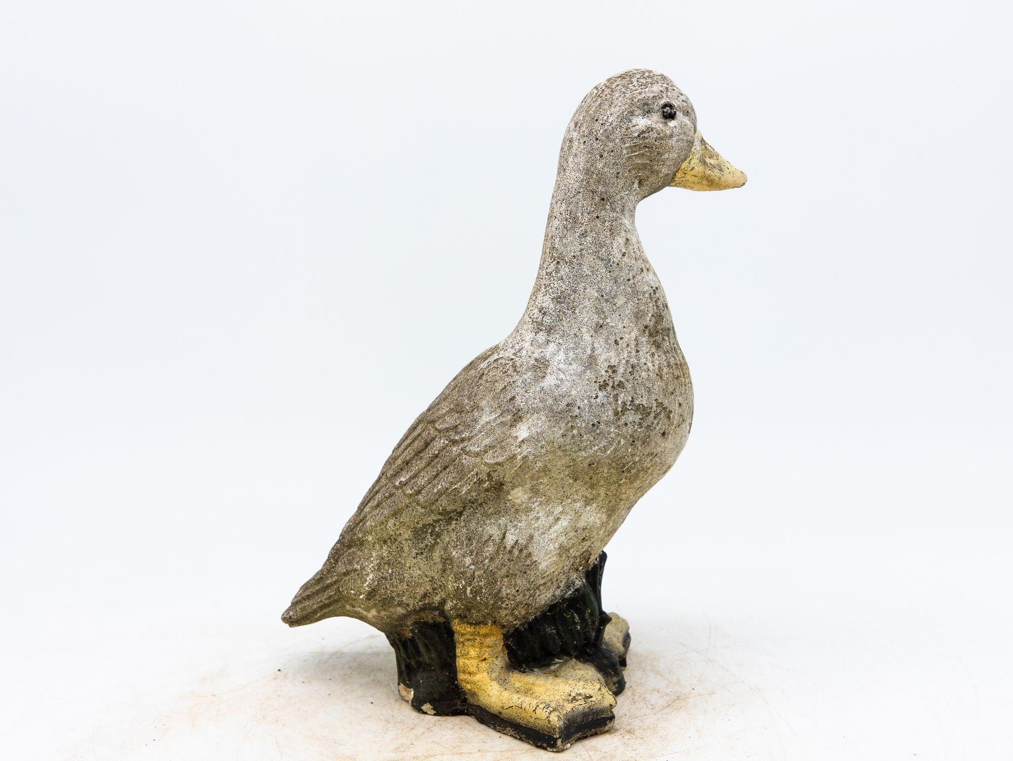 Capture the enchantment of a vintage French garden with this charming duck ornament. Crafted from durable concrete, it stands as a testament to both artistry and timelessness. The honest patina with remnants of paint adorning the surface tells a