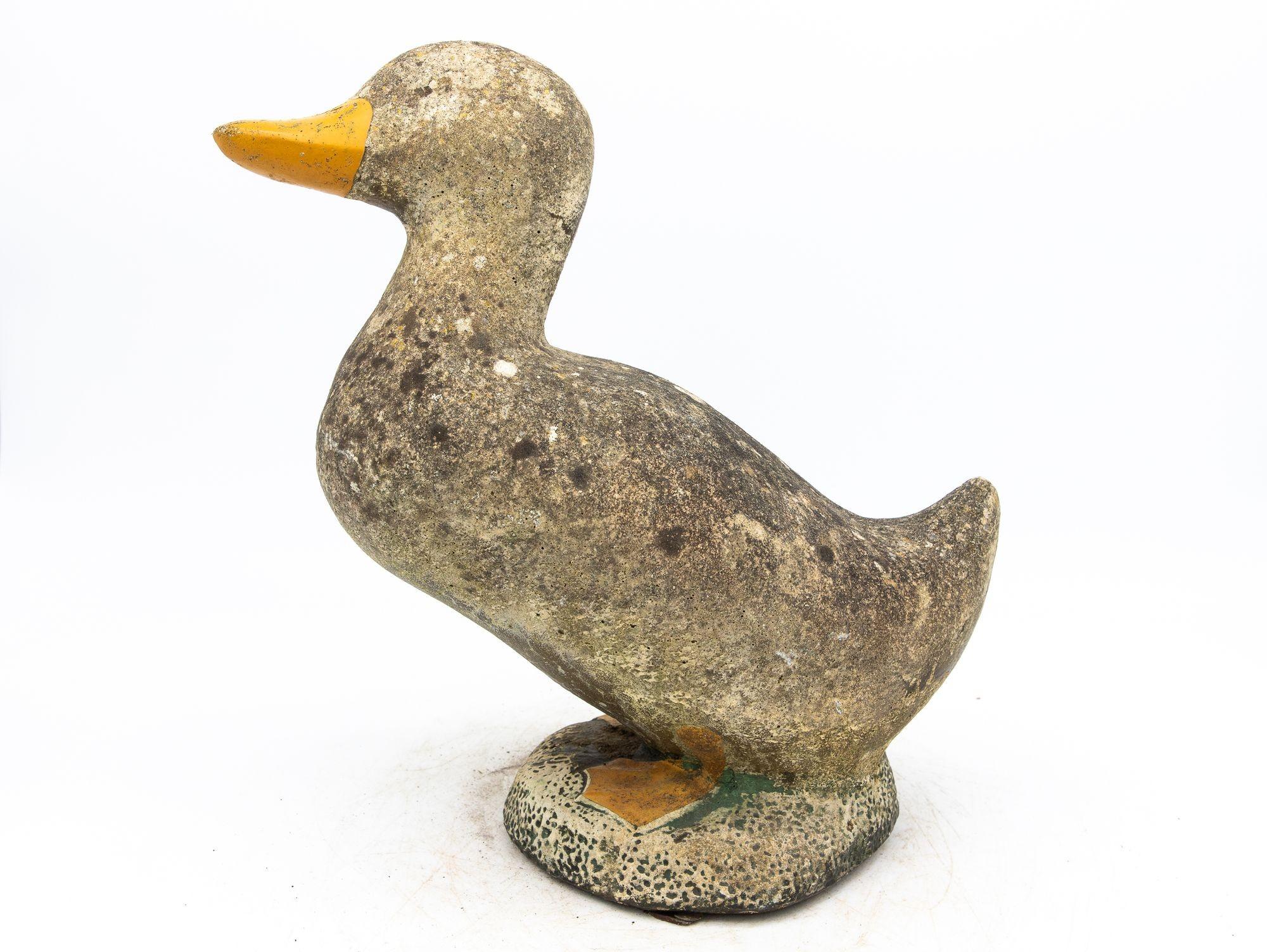 Capture the enchantment of a vintage French garden with this charming duck ornament. The honest patina adorning the concrete surface with remnants of yellow paint tells a tale of weathered beauty, adding character and authenticity. Wear consistent