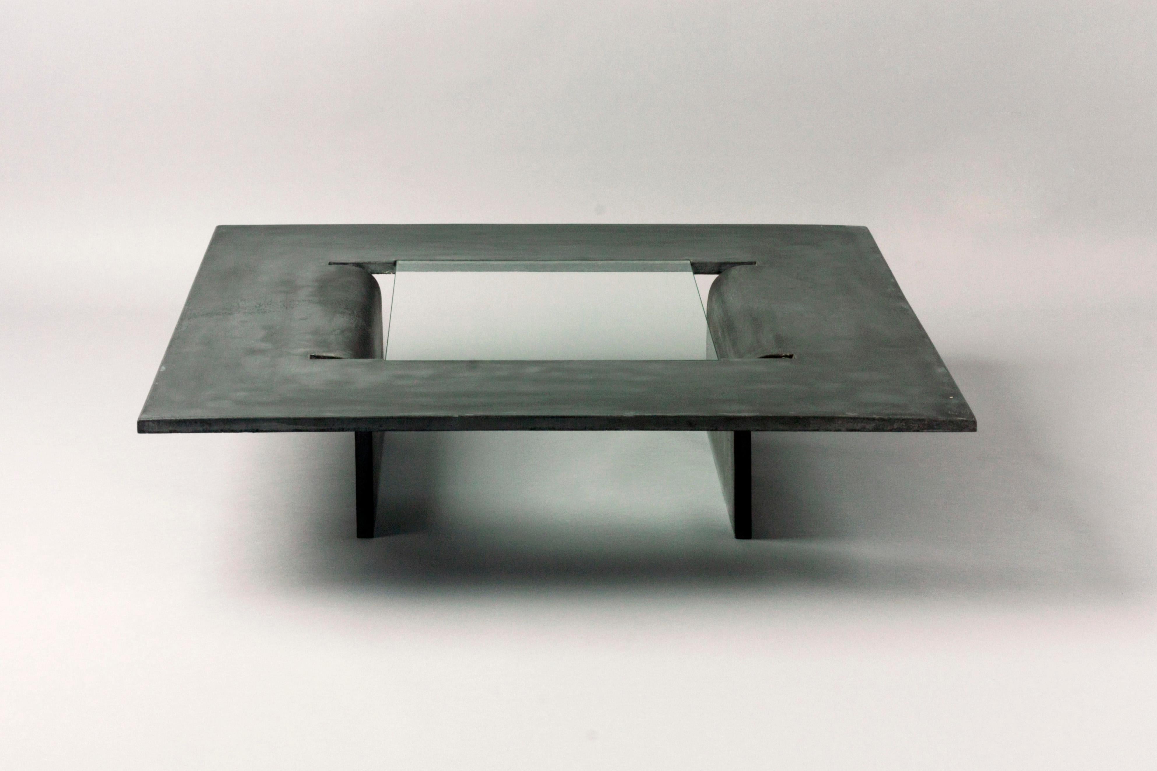 Made to Order, this coffee table is made of Fiber-Glass Reinforced Concrete. Inspired by the liquidity of the concrete material itself, the center is cut out and softly bent to create the table’s legs, and the gap is covered with glass to complete