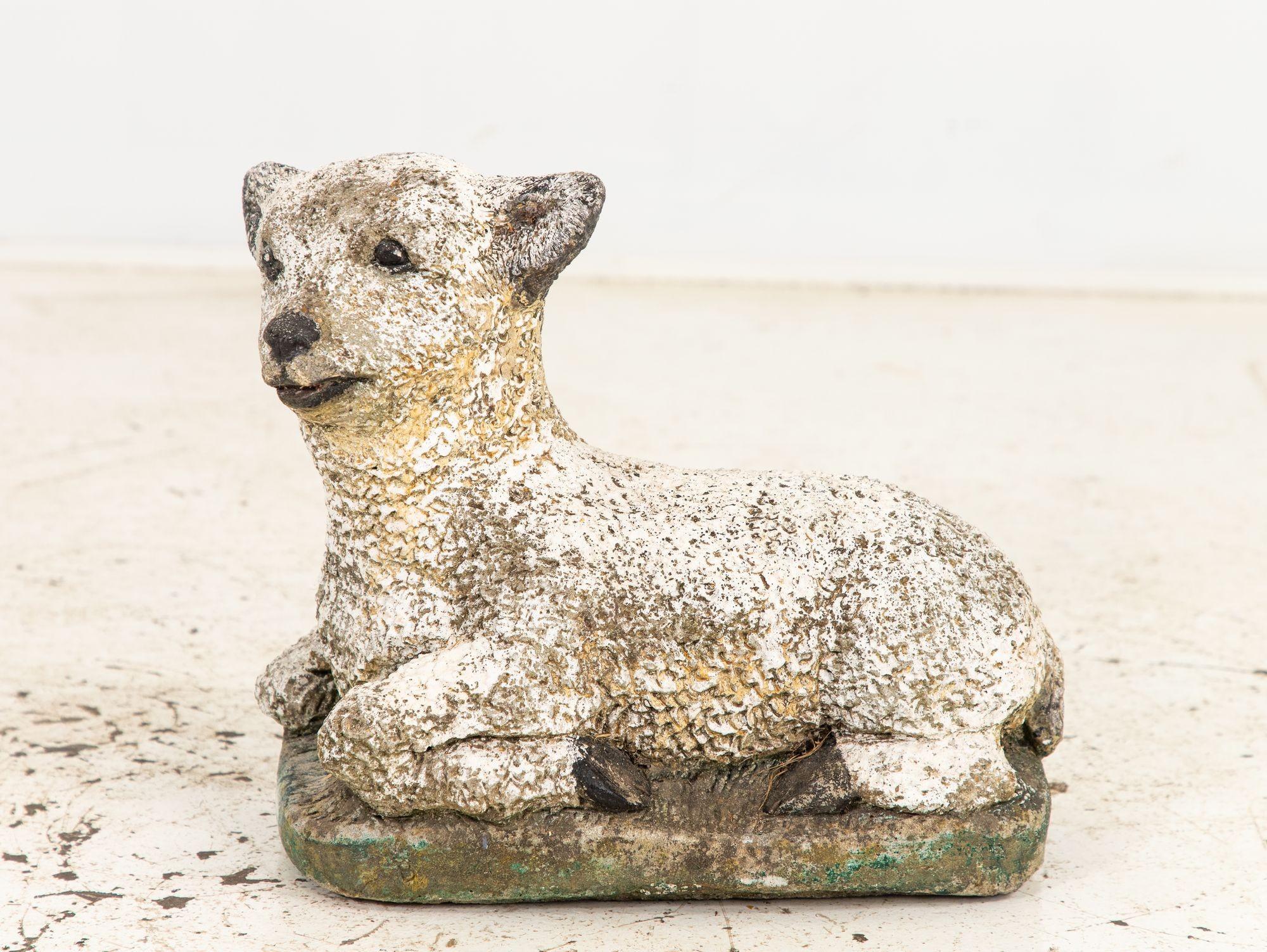 This charming French mid-20th-century concrete garden ornament features a lifelike representation of a lamb nestled in the grass, exuding an air of serenity and pastoral charm. The meticulous attention to detail shines through in the curly wool
