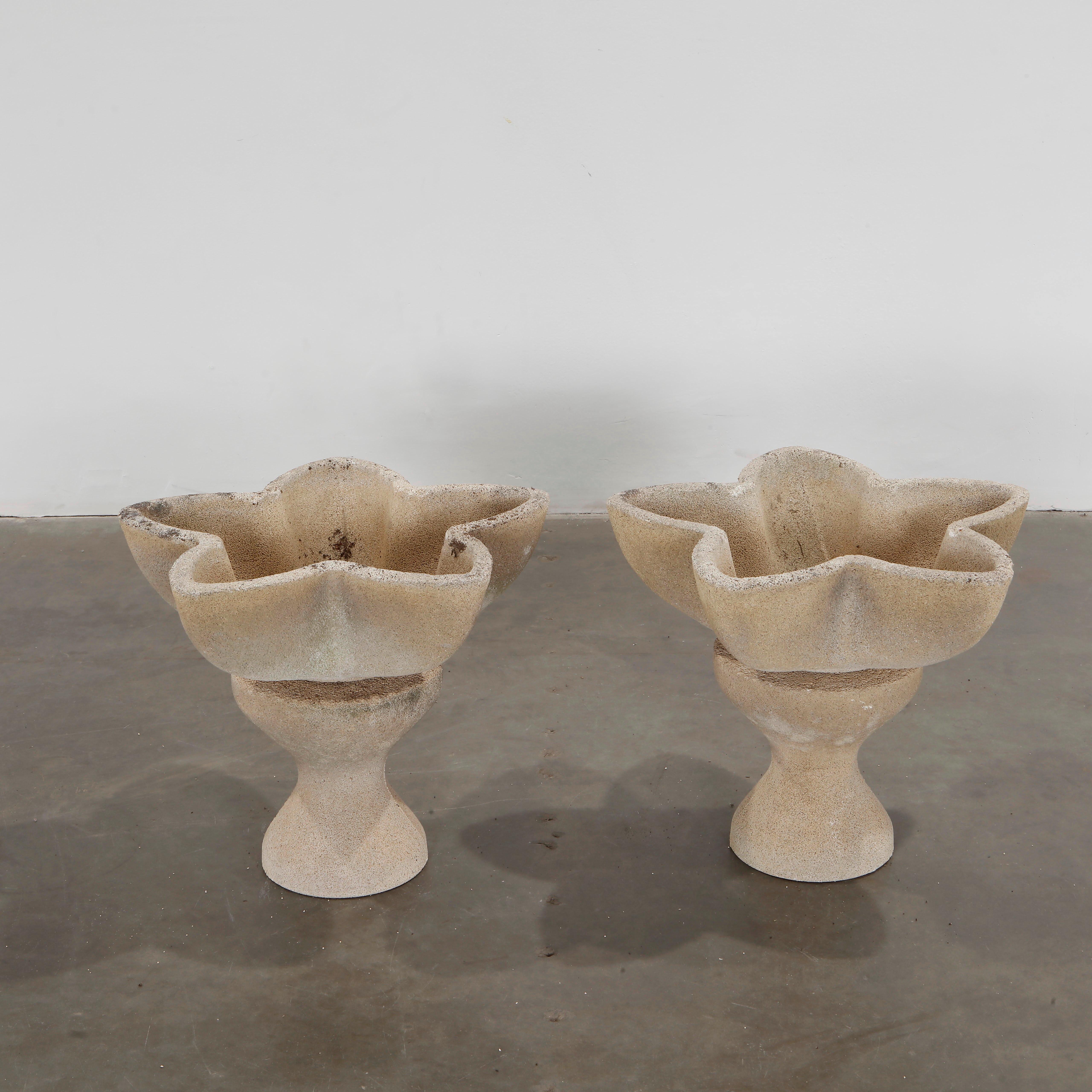 Brutalist-style planters with bold floral geometry. Raised on integrated column bases. Height: 17.5 in. Length: 17.5 in. Width: 21 in.