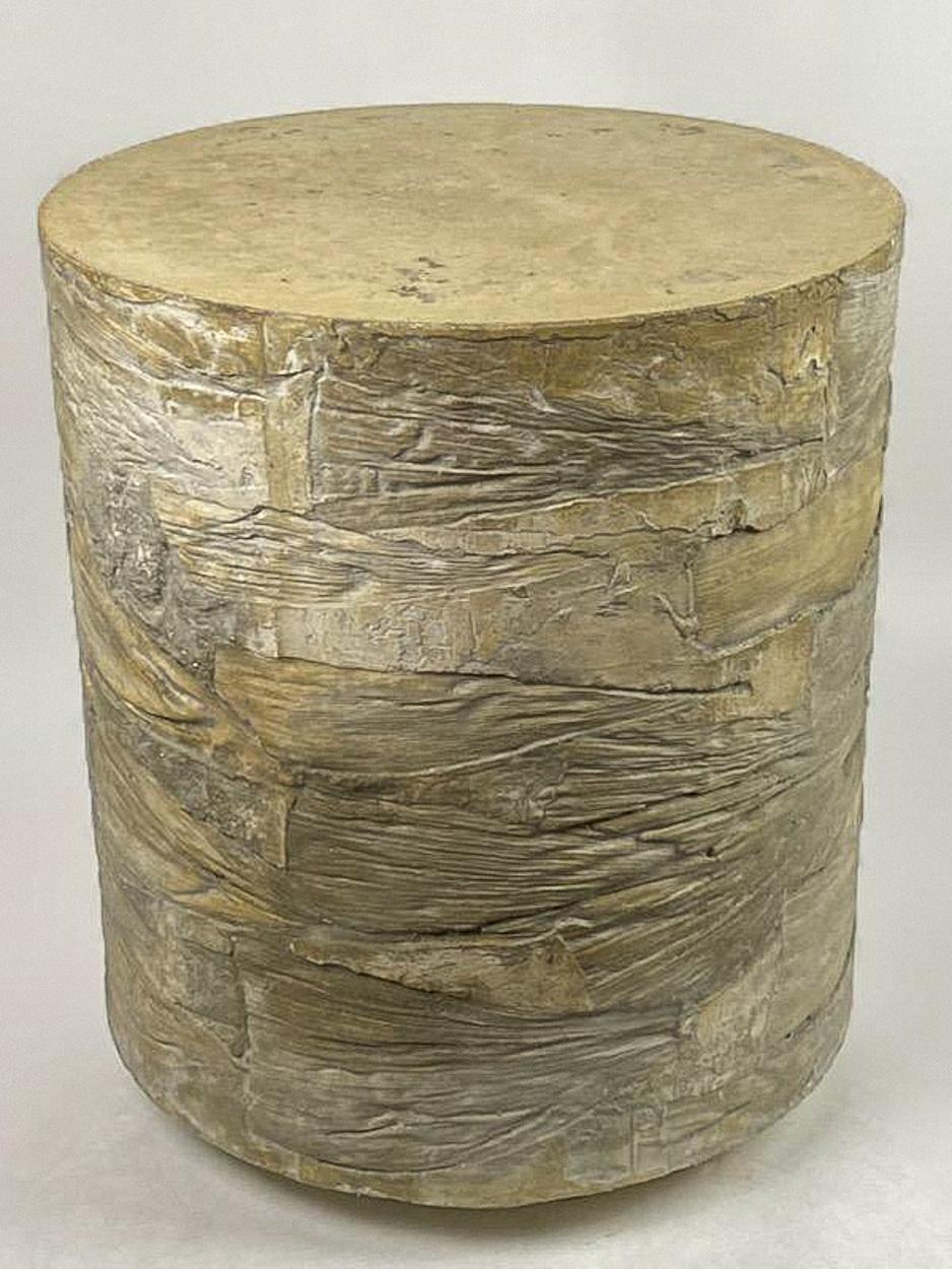A wheaty yellow concrete stool with horizontal corn husks embedded on the sides with intermixed abstract texture. Handpacked concrete made with Glass Fiber Reinforced Concrete (GFRC) techniques and recycled glass. Felt pads on bottom allow for