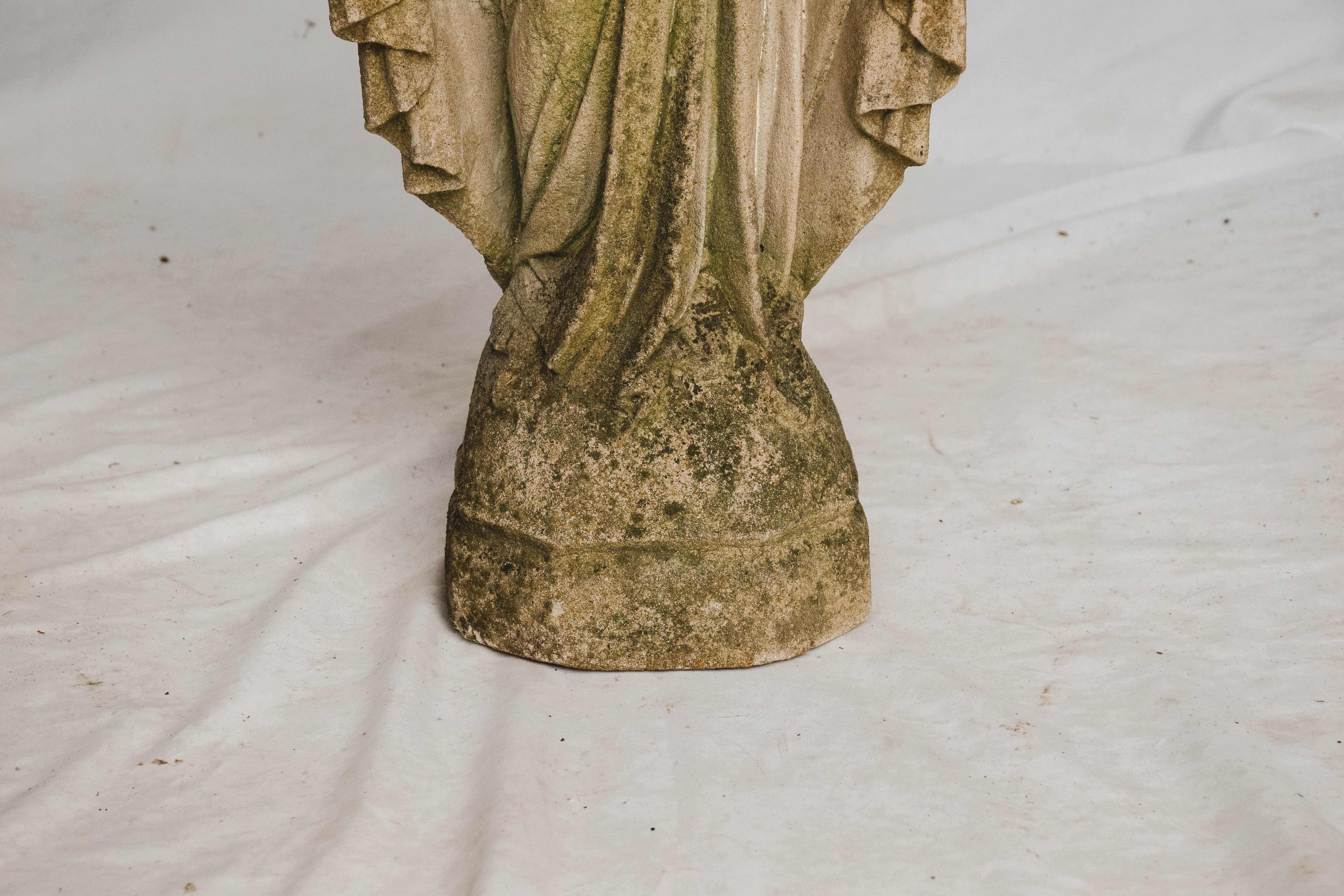 This is a concrete statue of The Virgin Mary. We believe this statue was once used outside of a church. The statue has a wonderful aged patina. This beautiful statue could be used in your home or garden.