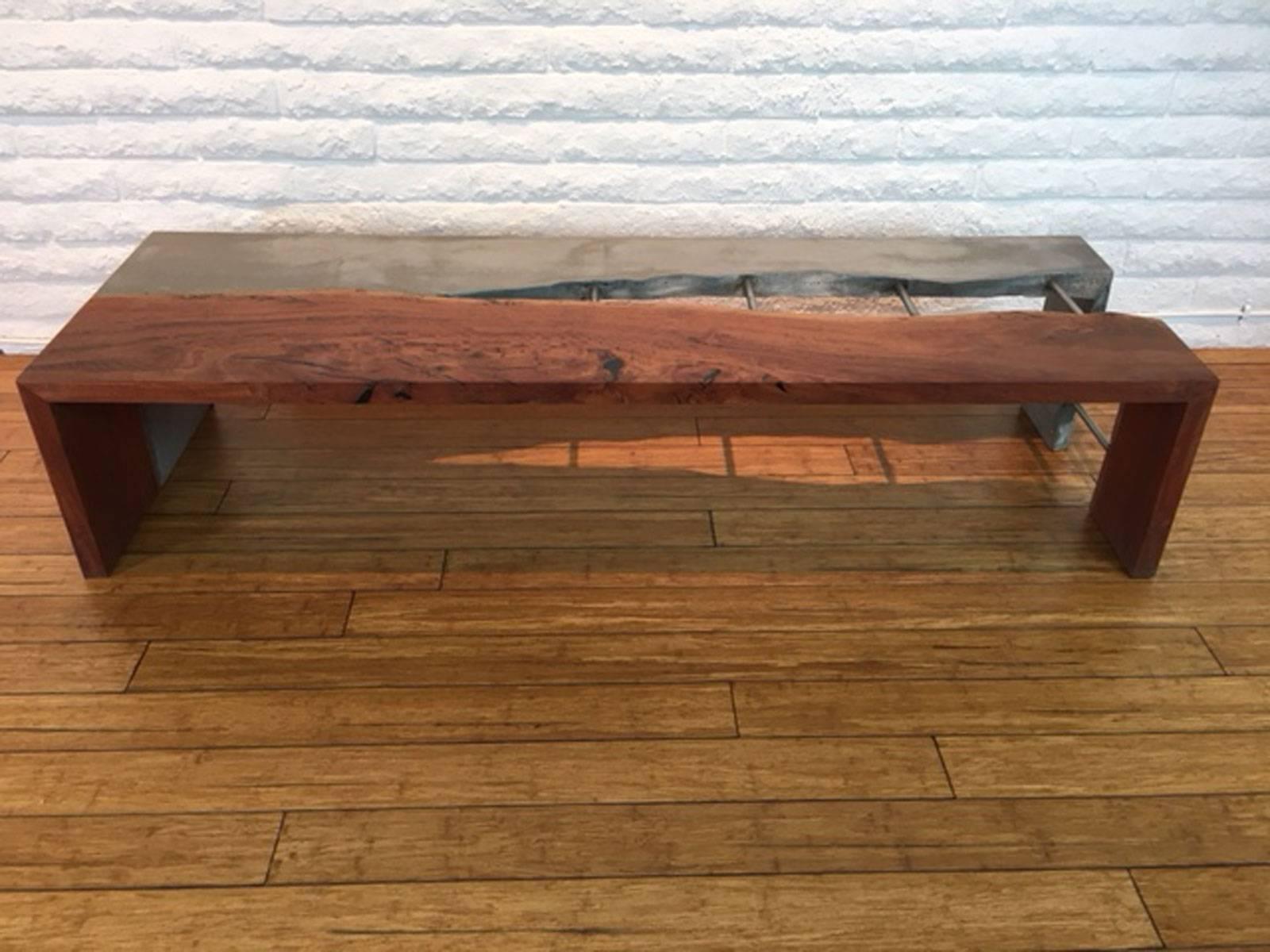 Concrete, steel bar, and eucalyptus wood bench designed, produced, and made by master wood artist and designer Scott Mills who only uses reclaimed (deadfall or storm downed trees) in the pieces he designers and produces. This piece is big, solid,