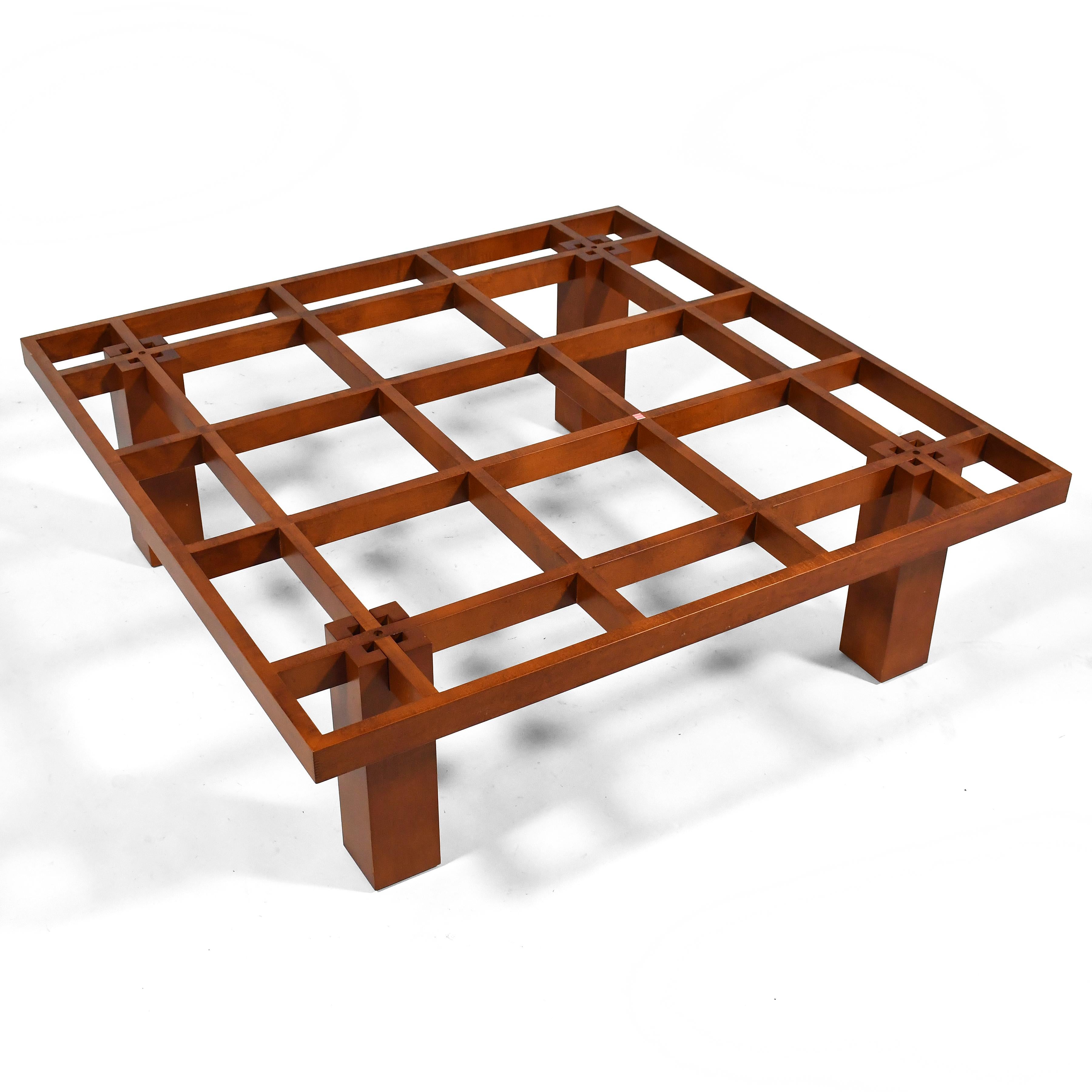 This handsome design by Conde House has a beautiful architectural quality. Crafted of cherry wood,  its grid-like top is supported by demountable legs. The original top was frosted glass, but it was damaged so it needs a replacement. We think it