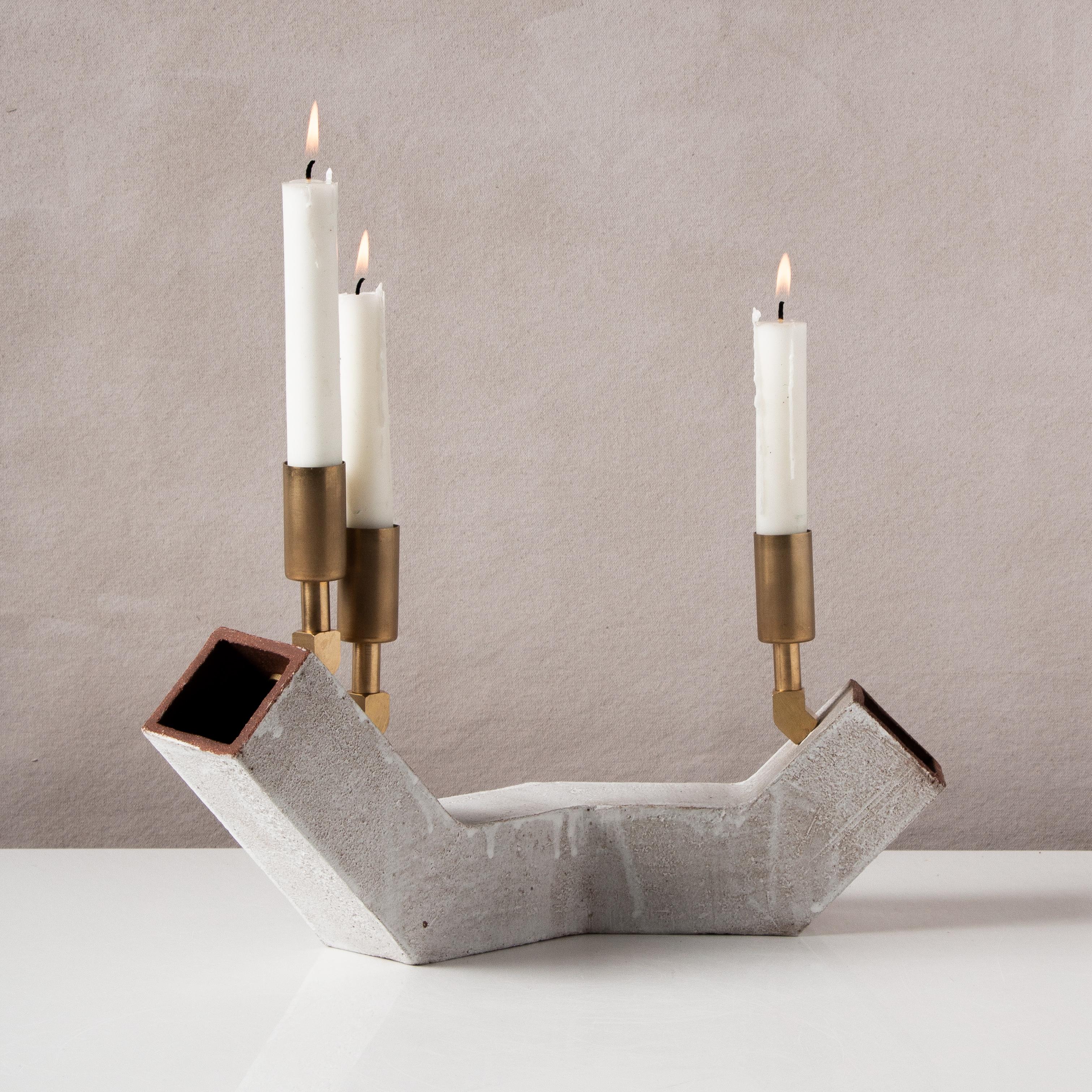 Inspired by midcentury Brutalist architecture and building materials, this candelabra balances a strong substantial base with delicate hardware. The base is handcrafted of rich red-brown stoneware with a velvety whitewash finish, upon which are