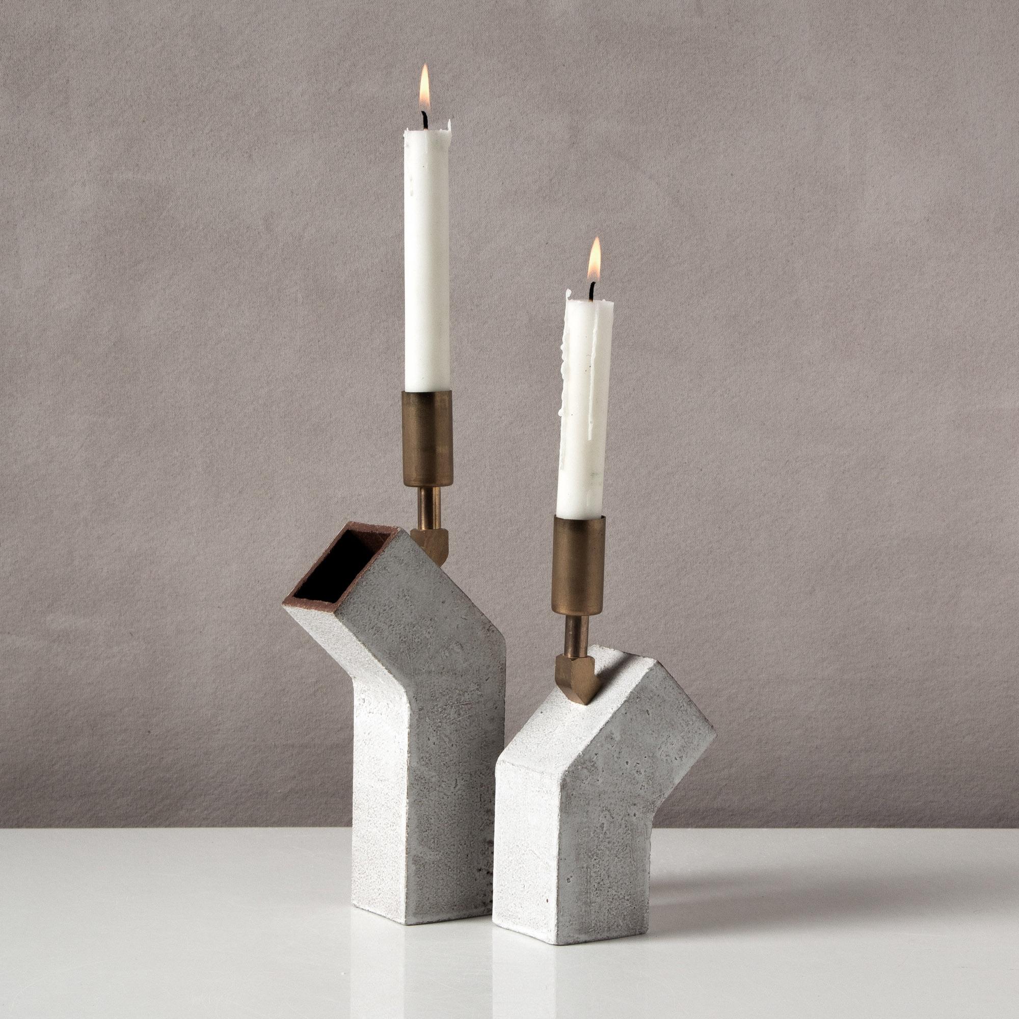 Inspired by midcentury Brutalist architecture and building materials, this pair candlesticks balances a strong substantial base with delicate hardware. The bases are handcrafted of sand-colored stoneware with a velvety whitewash finish, upon which