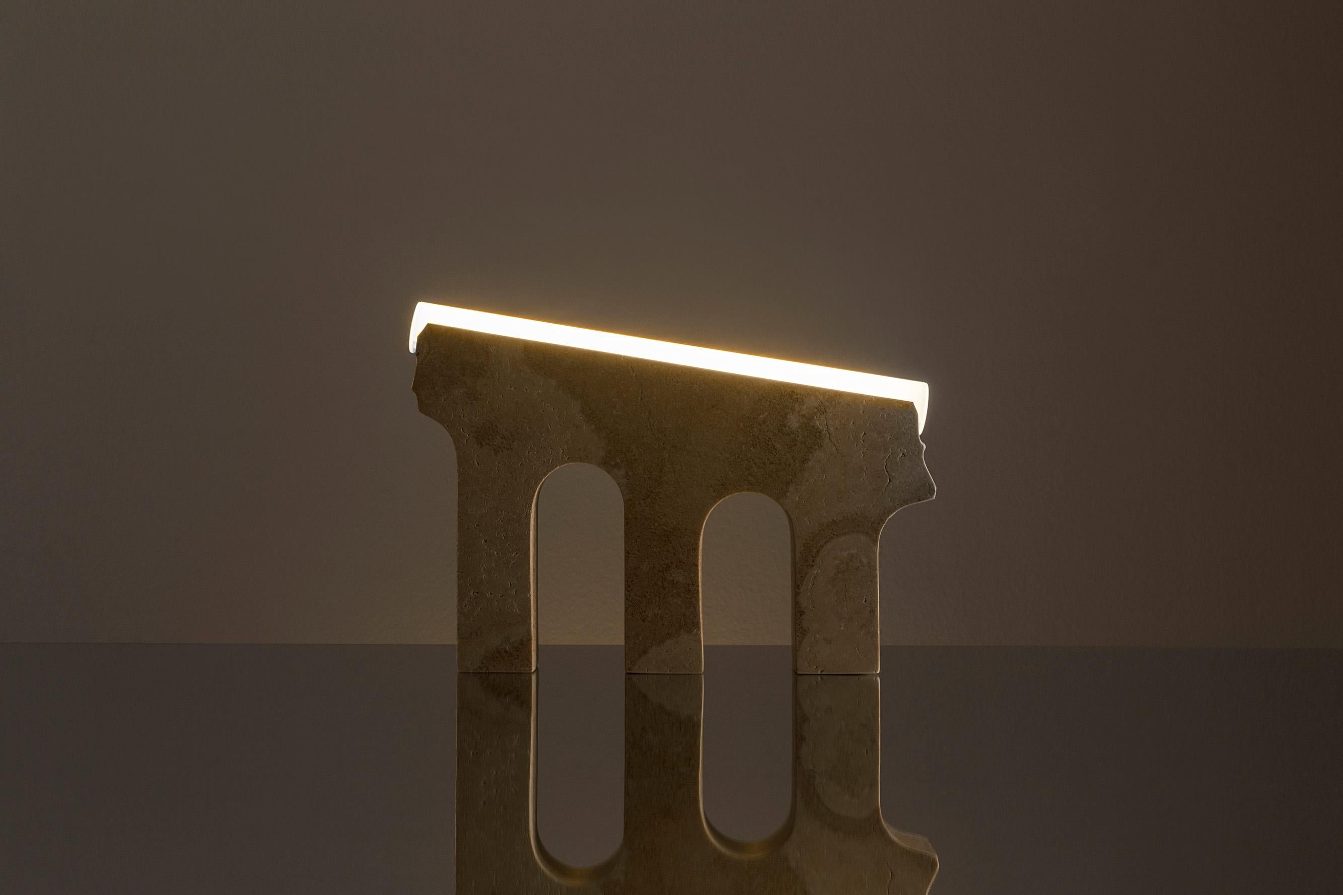 Austere in its beauty yet modestly playful, this marble lamp references an archetypal ancient aqueduct, thus creating a creating a “luminous conduit” for the home. 