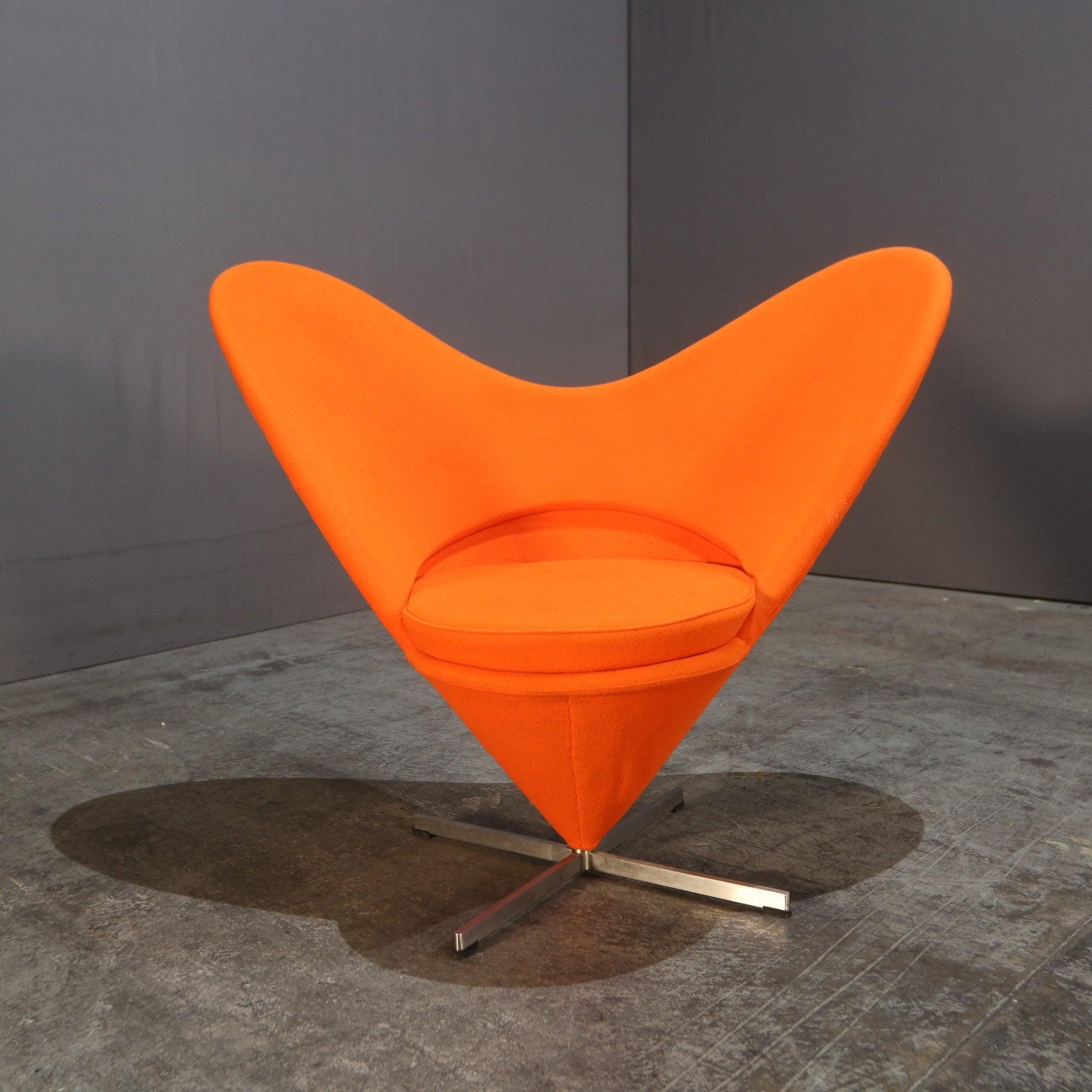 Introducing the iconic Cone Heart Chair by Verner Panton, a must-have piece for any modern luxury interior. Crafted with a sleek and sturdy chrome base, this chair features a unique heart-shaped backrest and a comfortable cone-shaped seat. The