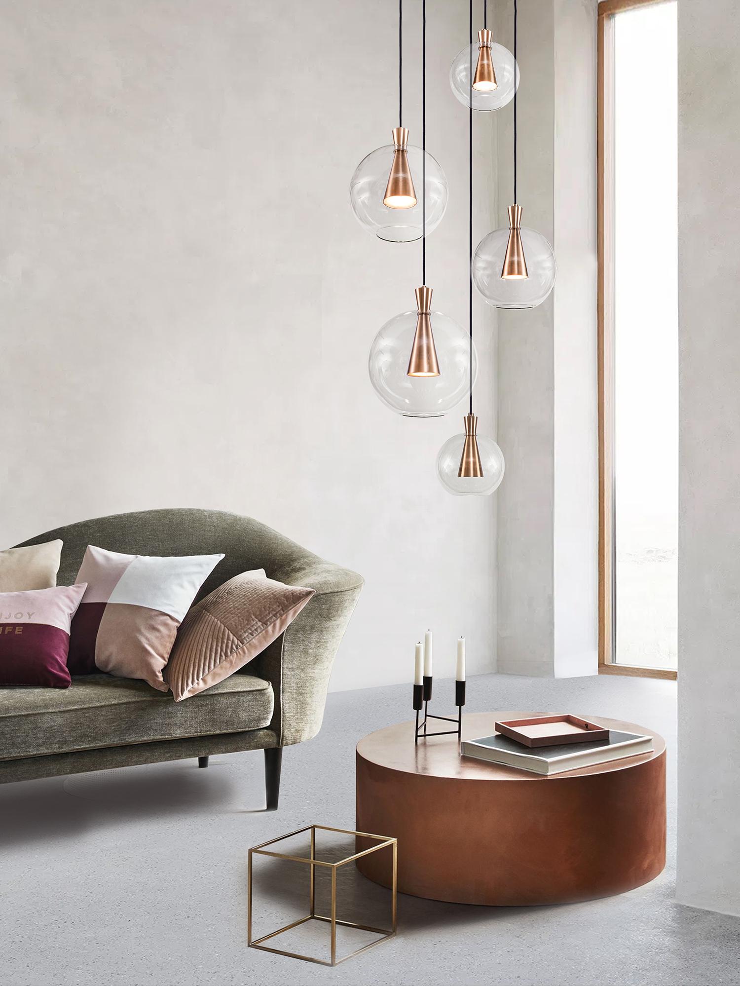 Cone is designed to showcase the beauty and timeless elegance of geometrical symmetry. Each cone is machined from a solid block of brass, with a hand-blown glass shade delicately suspended from the cones apex.
