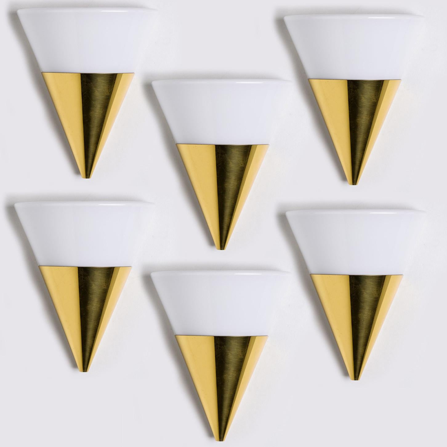 Cone shaped wall lights in white opaque glass with brass details. Manufactured by Glashütte Limburg in Germany during the 1970s. (early 1970s).

Nice craftsmanship. Minimal, geometric and simply shaped design.

Dimensions:
Height 9.84