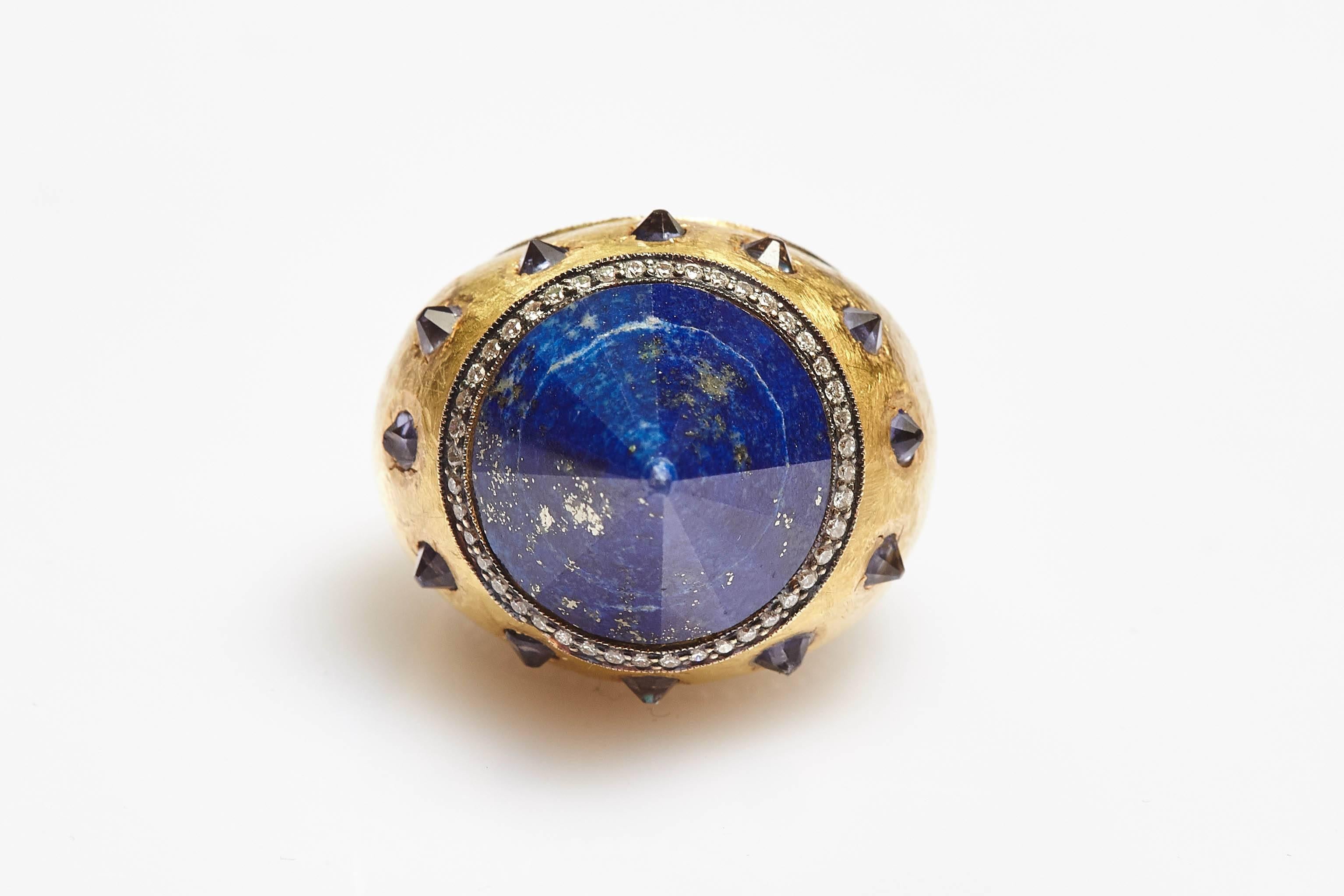 An unusual cocktail ring in 18kt yellow gold showcasing a sodalite cone, highlighted by diamonds and smaller sodalite elements. Made in Italy, circa 1970s