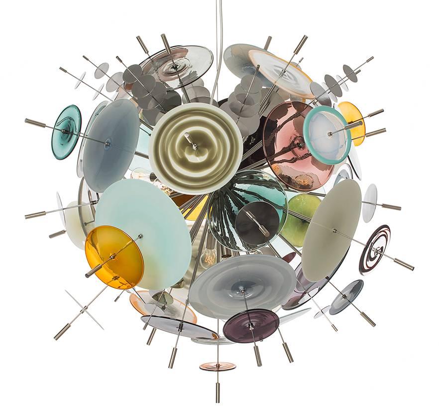 The Confetti glass chandelier features handblown glass discs in a variety of color palates with a choice of metallic accents. Pictured: topaz, slate, aqua, olive, teal, ivory, opaline, orange, black and white. Please contact the studio for more