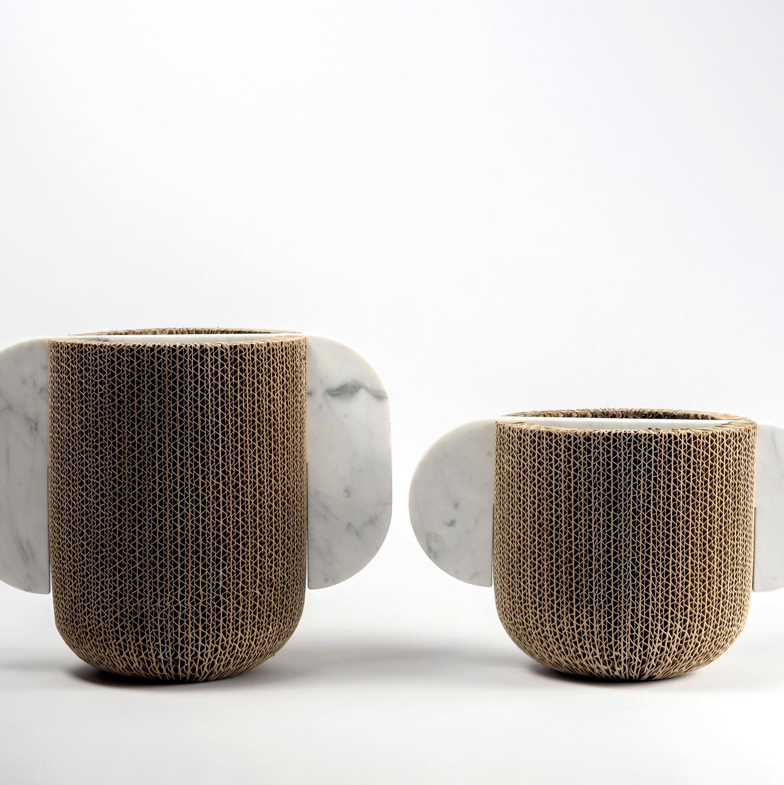 Vases. Material boundaries authenticate each other. Circumscribed forms, complementary to the identity of becoming. A collection of four vases that connect opposing materials: marble and cardboard. Light and heavy, solid and fragile, unalterable and