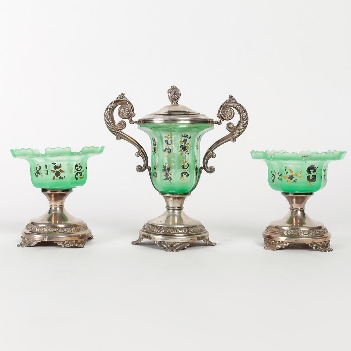 Confiturier and its two jam display stands, Antique Charles X period.

Enameled green opaline confiturier on silver base, stamped with Minerve, with its two opaline and silver jam display stands, 1830, Charles X period antiques.

Dimensions:

Jam