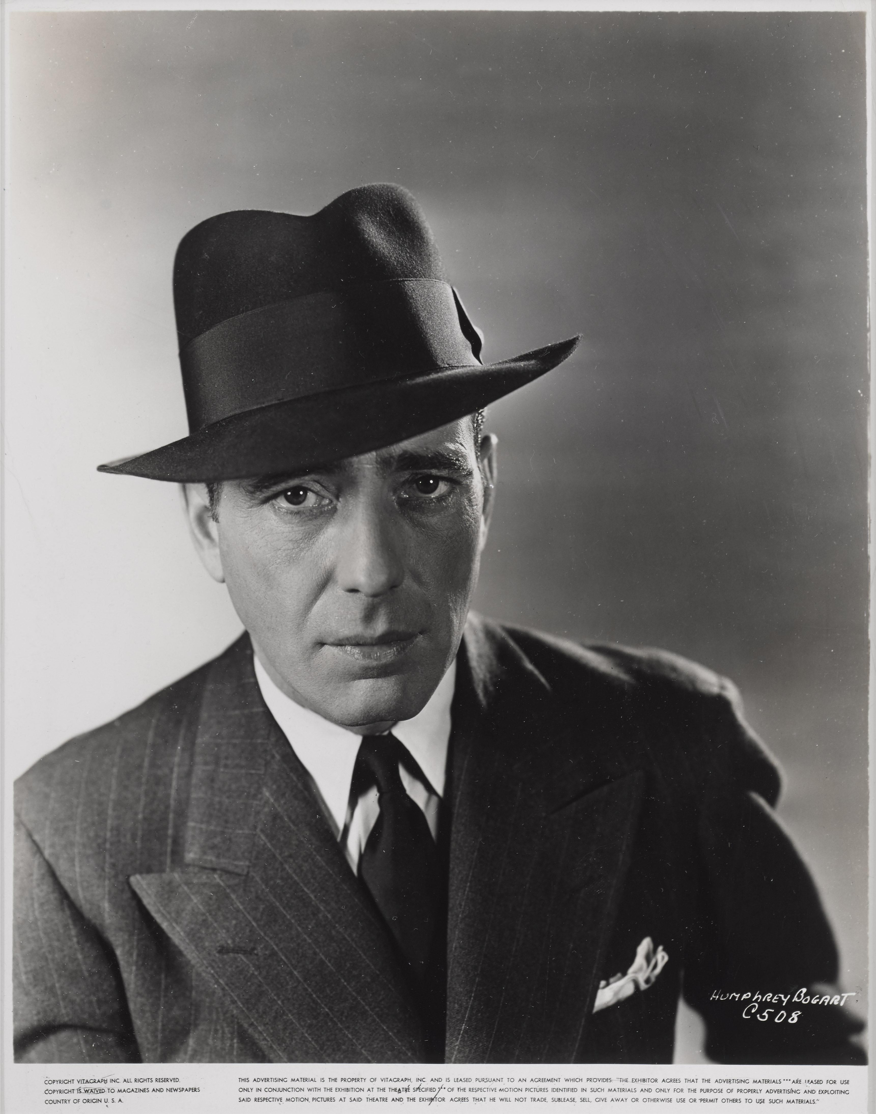 Original photographic production still used by the studio to advertise the film. these stills were sent out to news papers. This piece shows a great image of Humphrey Bogart as architect Richard Mason. This film was directed by Curtis