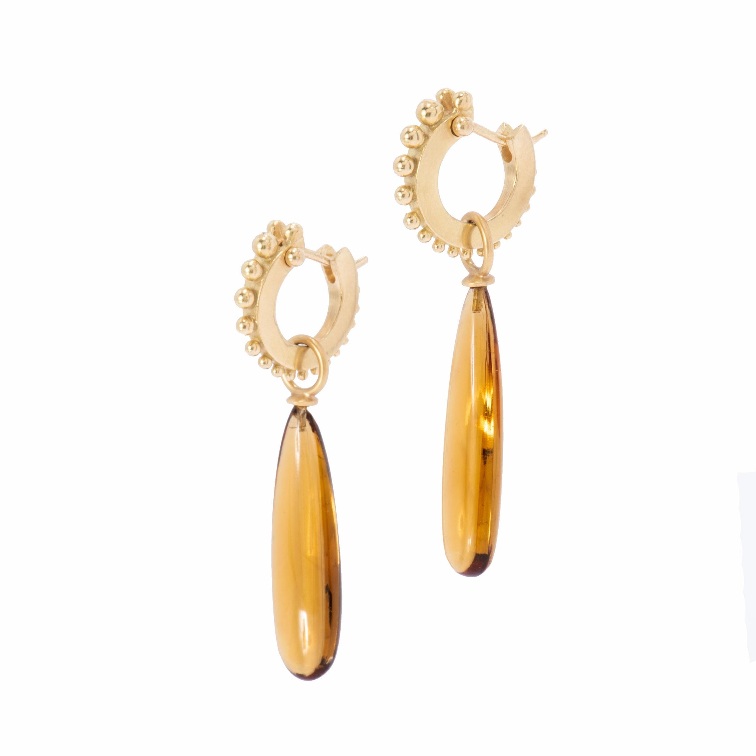 Congolese Citrine Wand Drop Earrings in 18k gold gleam with honey golden light. Fitted with caps and bails in 18k gold and handcrafted in our studio, they hang from our narrow beaded hoops which click tightly shut for security. Congolese citrine