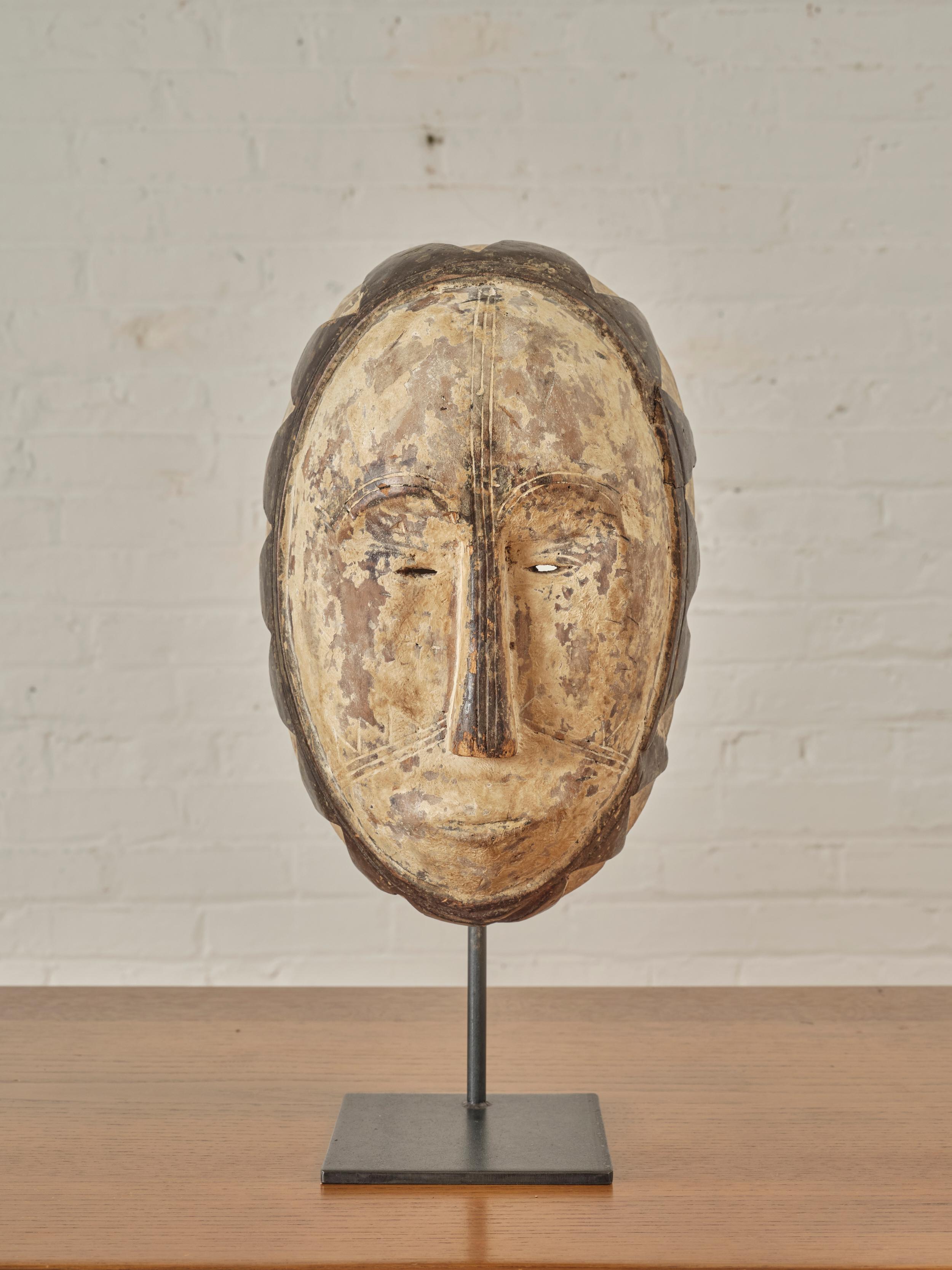 Congolese Fang Carved Mask Sculpture on a metal base. A 