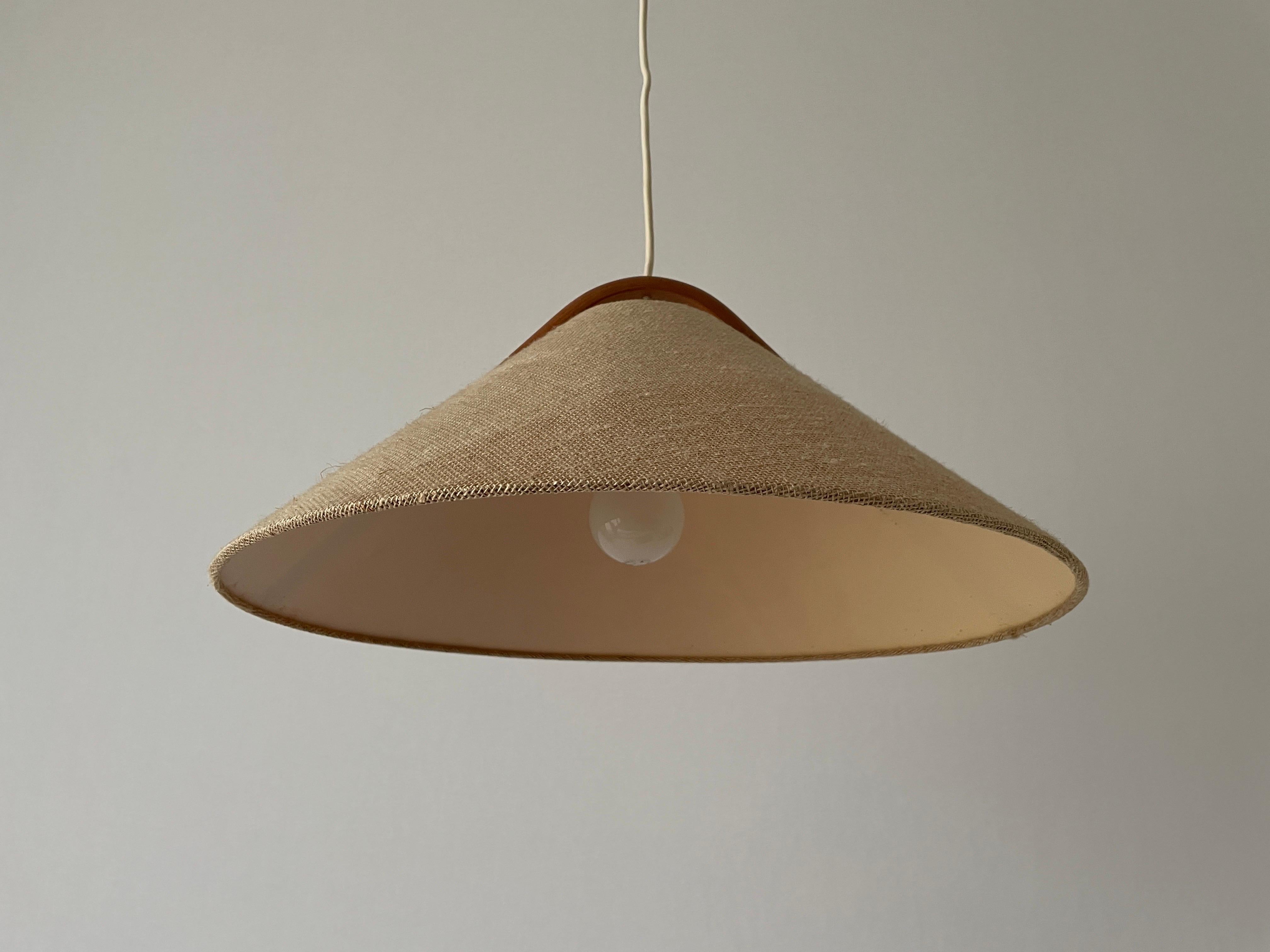 Conic Design Fabric Pendant Lamp with Teak Detail, 1960s, Germany

Minimalist and rare design. 

Lampshade is in good condition and clean. 
This lamp works with E27 light bulb. 
Max 100W Wired and suitable to use with 220V and 110V for all