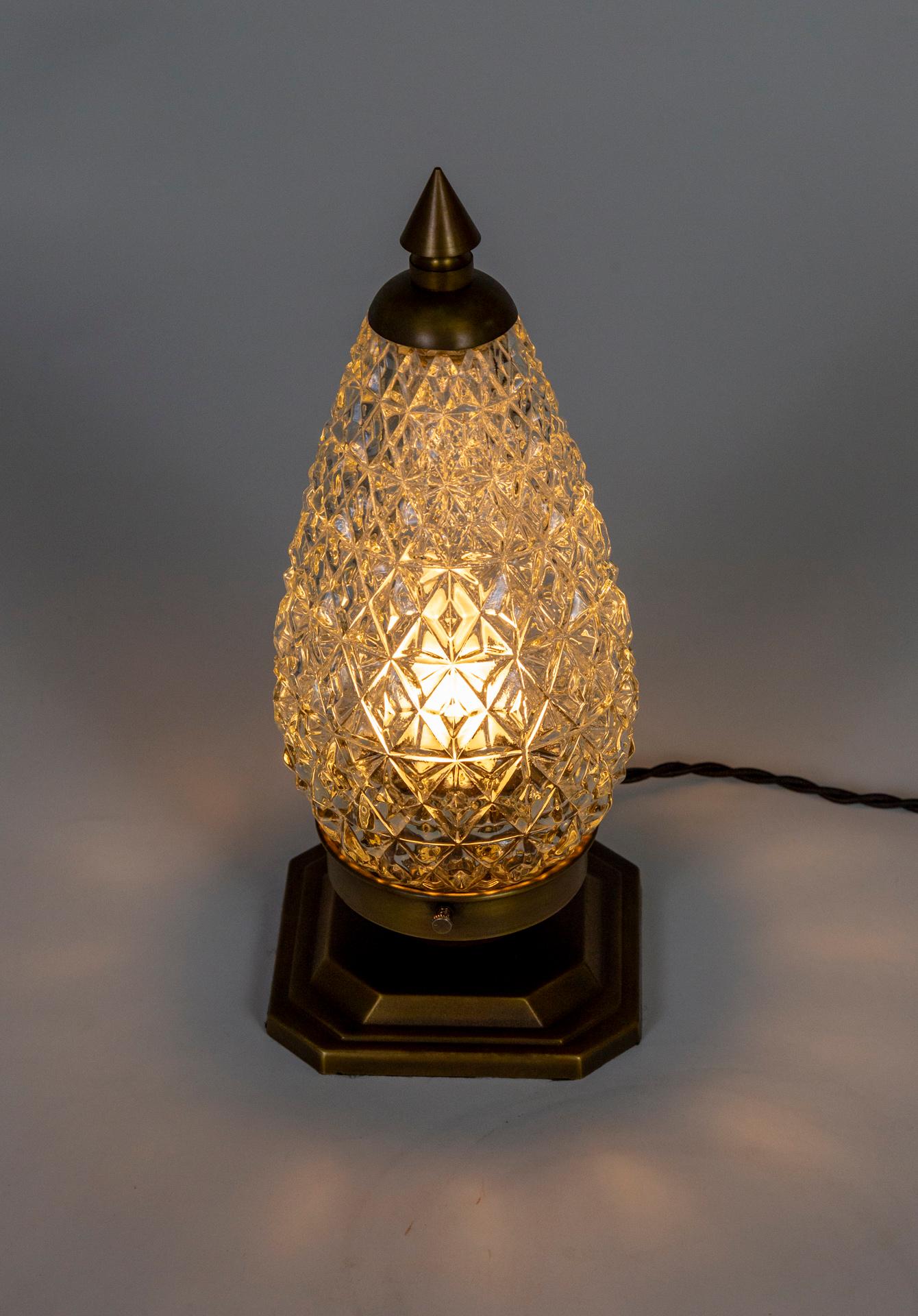 A vintage, cone shaped shade - in quilted pressed glass creating a diamond effect, repurposed into a petite lamp with solid brass parts. Newly wired with a dimming switch on the cord. The petite shape and dimming capability make it perfect for mood