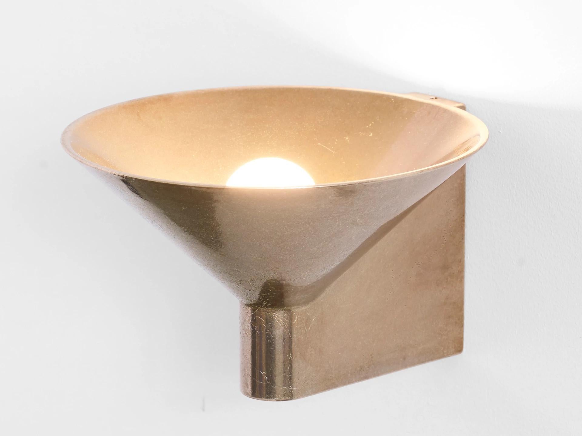 Sculpted bronze sconce light by Henry Wilson
Lost wax cast in solid bronze, the conical up light is our most complex production casting to date. Each piece is hand finished and can be mounted to any surface as an up or down light, using a discrete