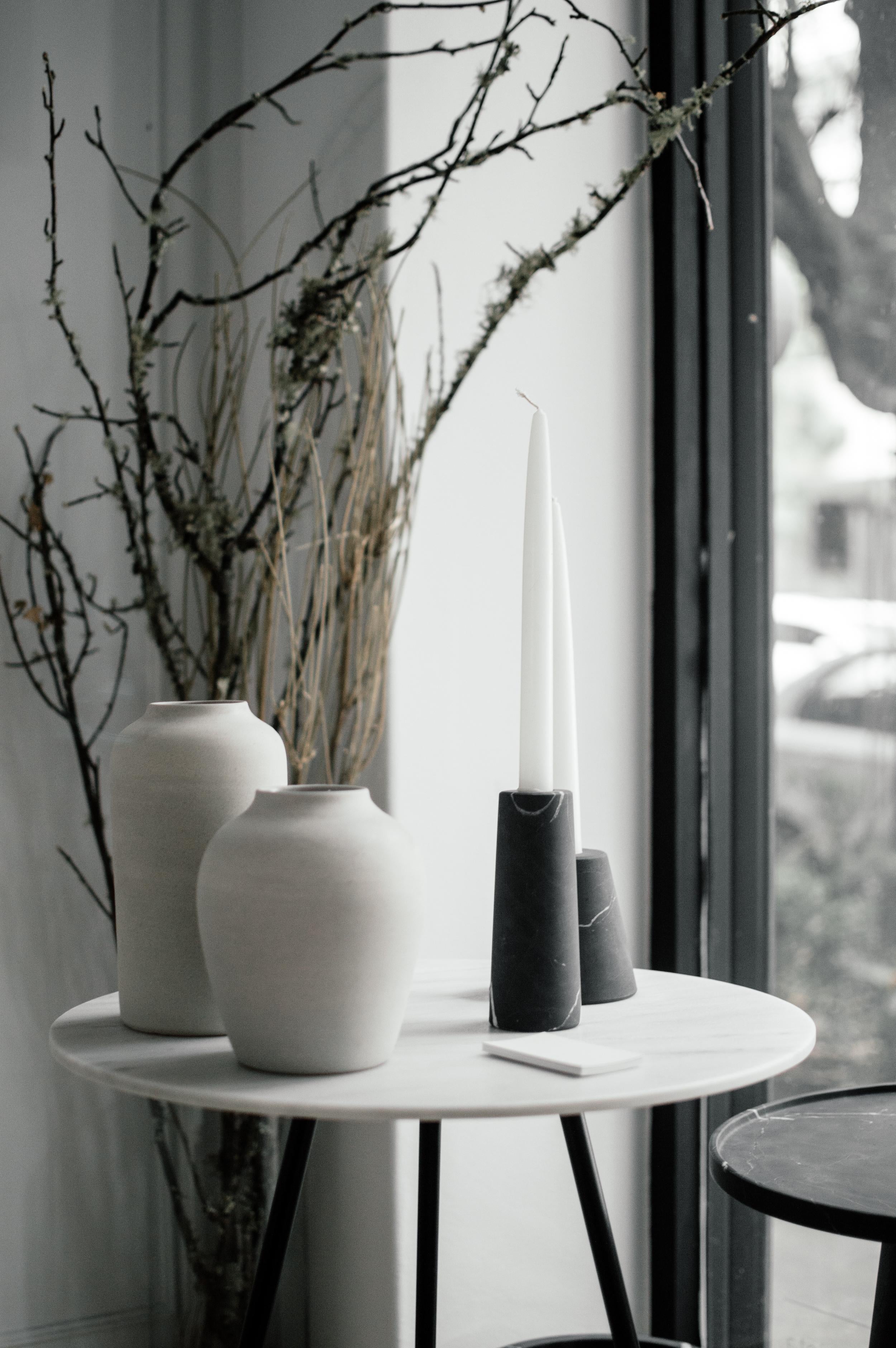 Two candleholders in Monterrey black marble. Handmade in MÃ©xico by local craftsmen.   Dimensions:  Small: 10 D x 10 W x 10 H cm Large: 6 D x 6 W x 15 H cm.  Production time: 6-8 weeks for items without marble / 13-14 weeks for marble pieces.