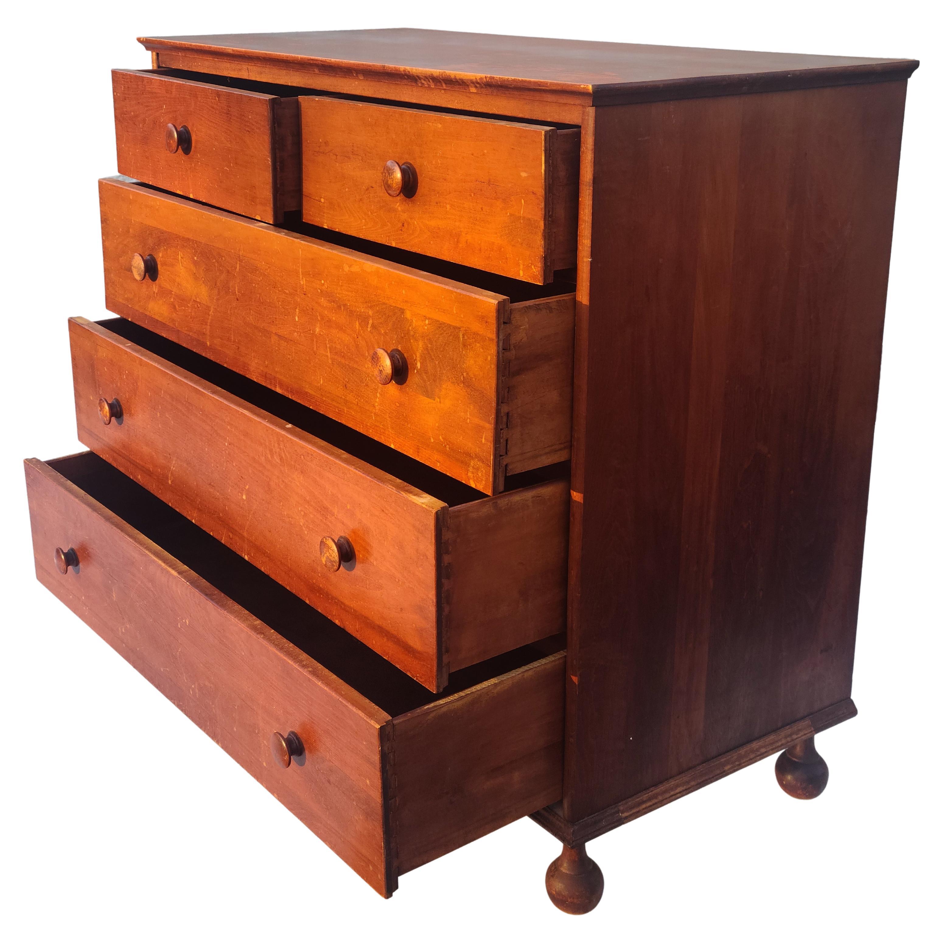 Connant Ball 5 drawer chest. American Revival circa 1935. These legs are really lovely. The chest appears to have had a faux bird's-eye finish. The finish on the top is not perfect. The overall patina is pretty nice. We can lightly refinish the top