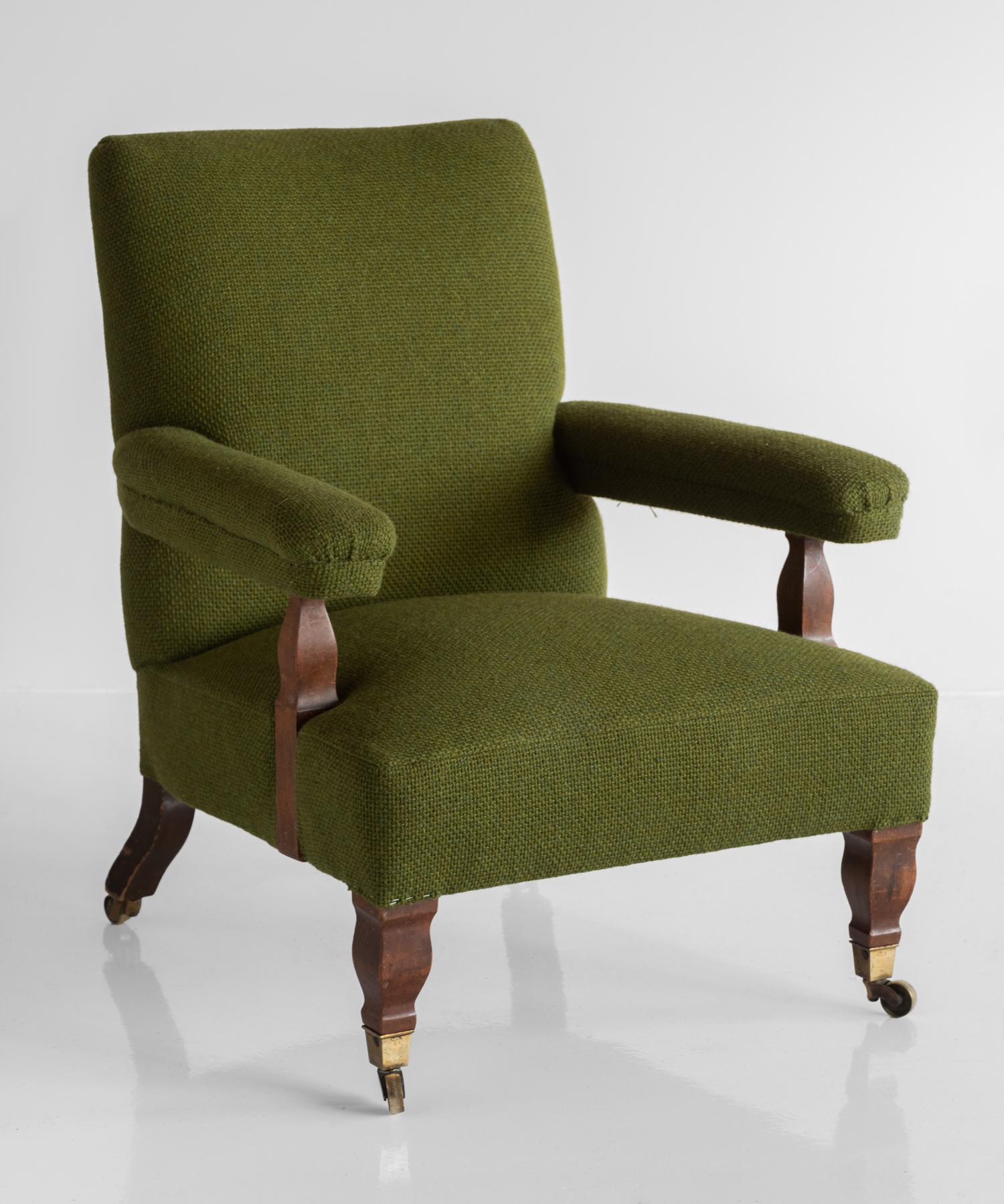 Connaught upholstered armchair, England, circa 1890.

Handsome frame on original brass castors. Newly upholstered in olive green wool super weave by Maharam.