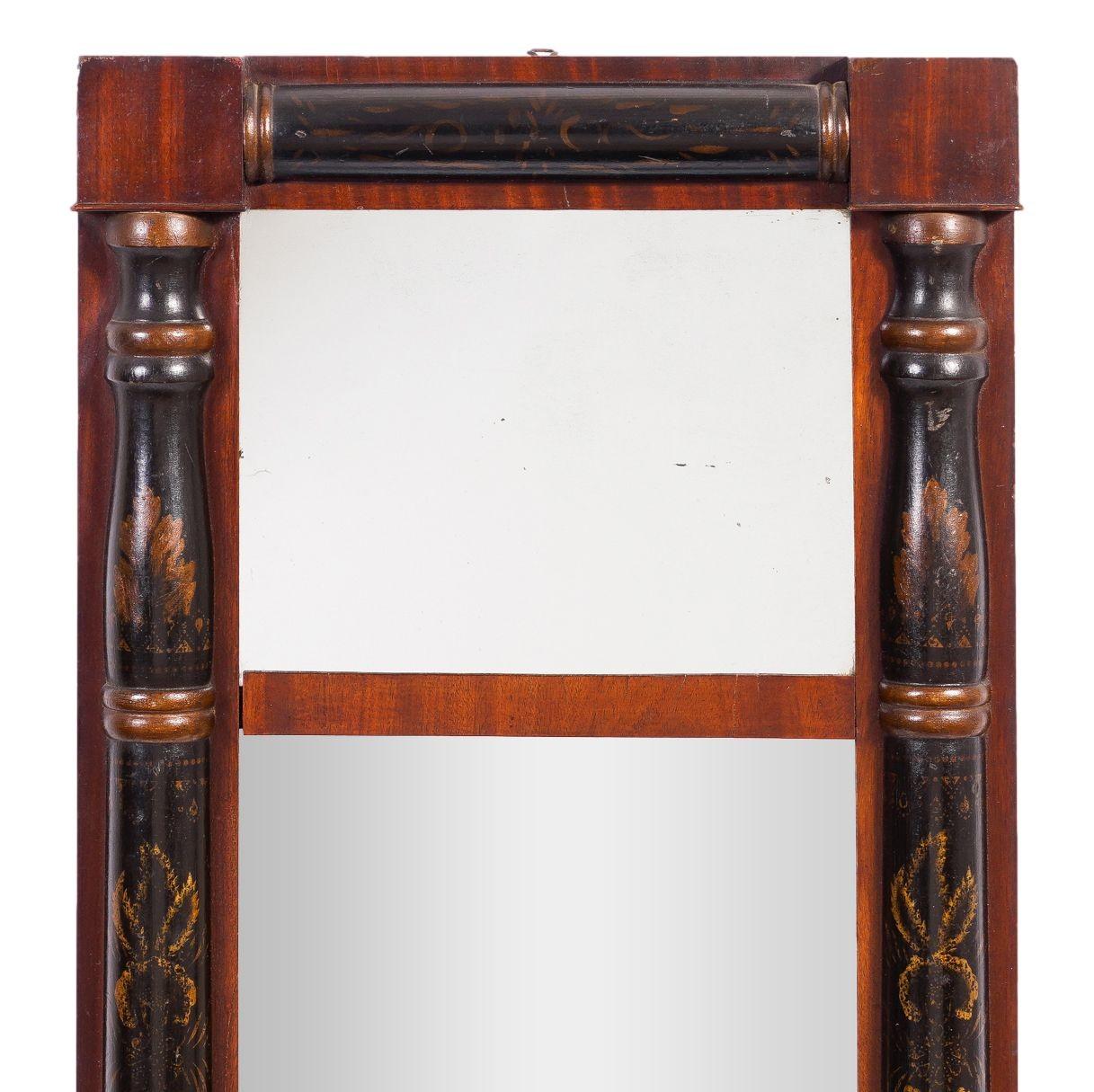Small-scaled American Neoclassic split baluster two part mirror. The frame features ebonized half columns contrasted with mahogany corners blocks and framing substrate. Gilt and bronze stenciled decoration on all four turnings.

Upper Connecticut