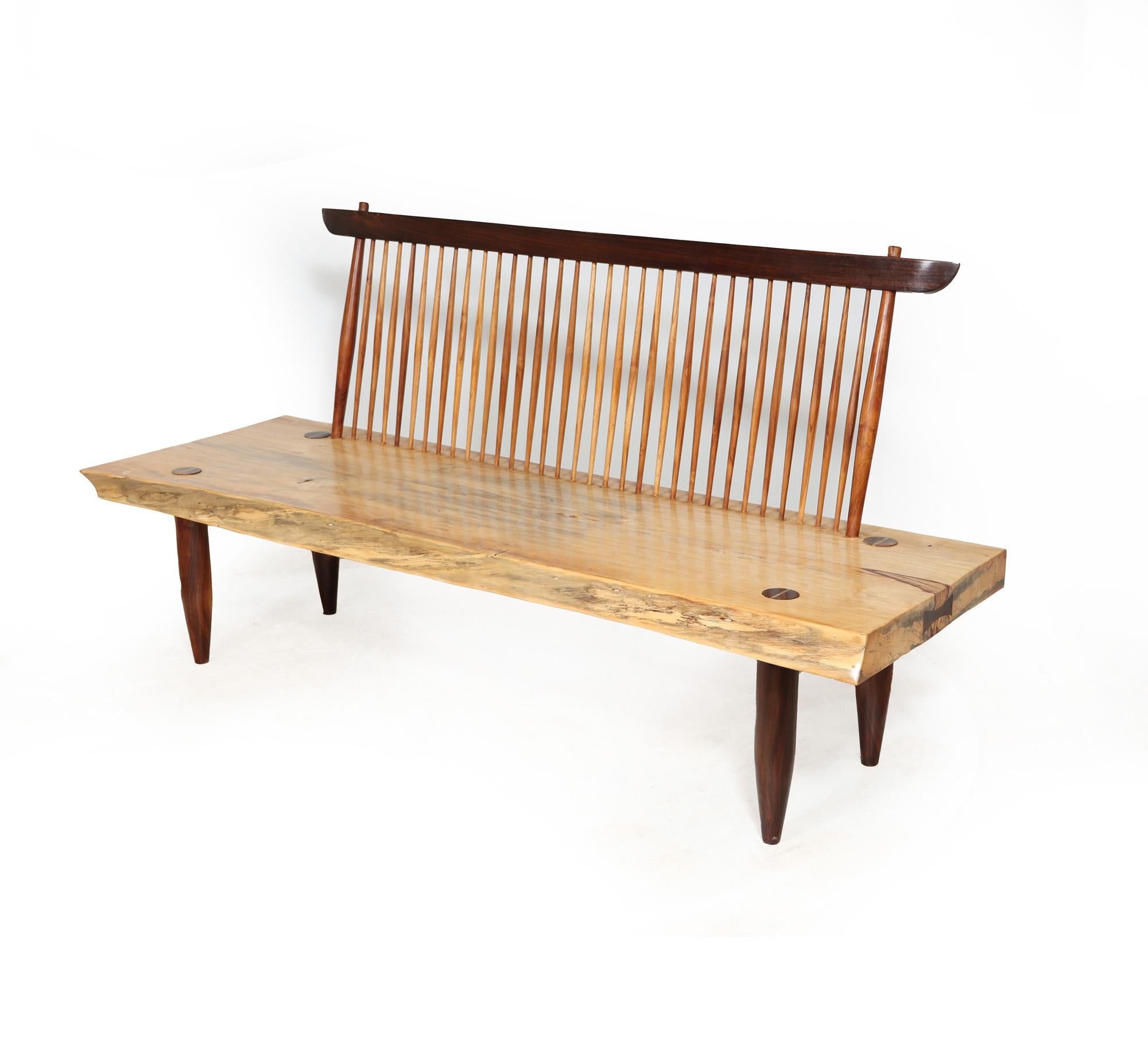 CONOID BENCH - NAKASHIMA C1980
George and Mira Nakashima style design Conoid bench, a stunning piece of furniture from the late 20th century. Crafted with precision in Teak and exotic wood, this sofa embodies the renowned American designer