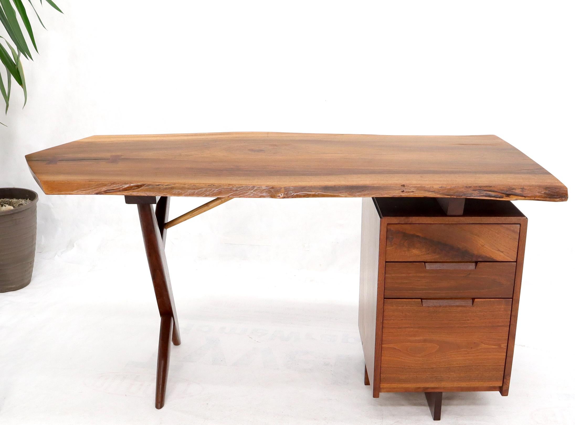 George Nakashima solid walnut conoid cross leg desk with butterfly joint or lock. Dated and documented Nakashima piece retaining original paperwork (slightly in as is pictured condition).