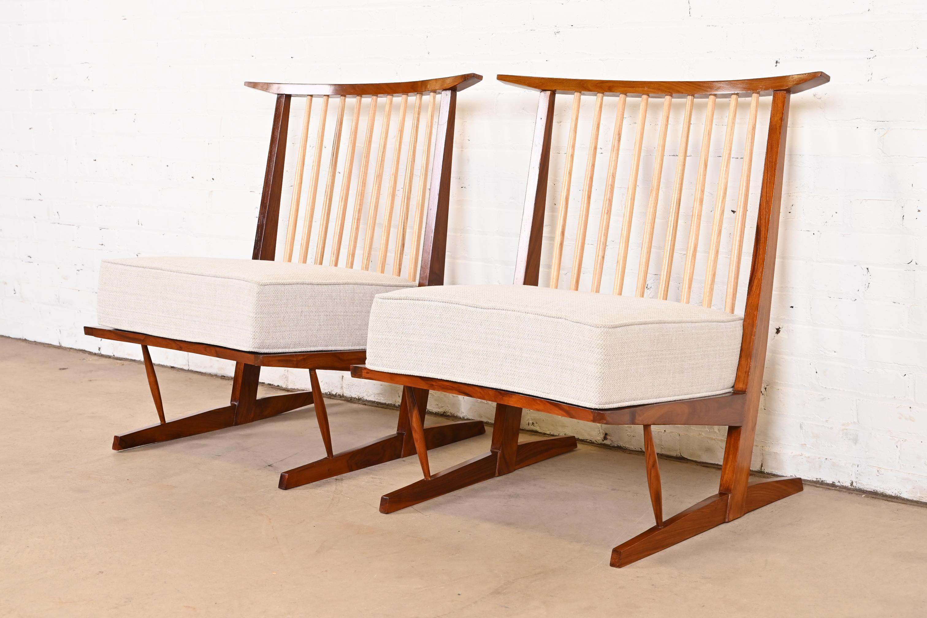 An exceptional pair of Organic Modern lounge chairs

After George Nakashima

USA, Circa Late 20th Century

Sculpted walnut frame, with contrasting hickory spindles, and removable upholstered seat cushion.

Measures: 23.25